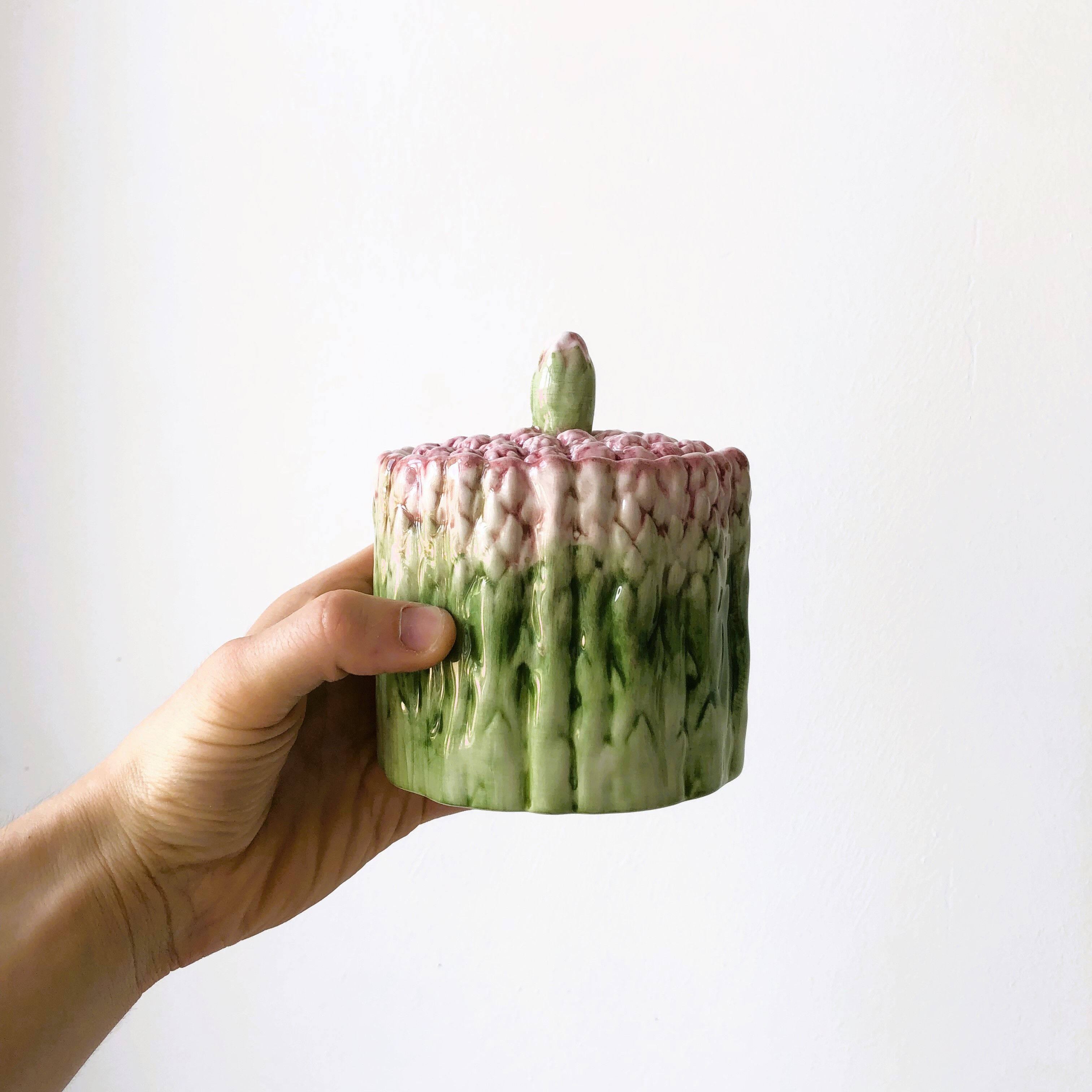 Old mustard pot and its slid in slurry decoration bunch of asparagus.