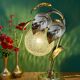 Vintage lamp with brass leaf design and transparent glass globe.