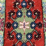 Vintage hand-knotted wool rug with polychrome decoration on a red, blue, green background 150 x 63 cm