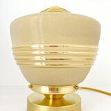 Old globe table lamp in beige and gold glass