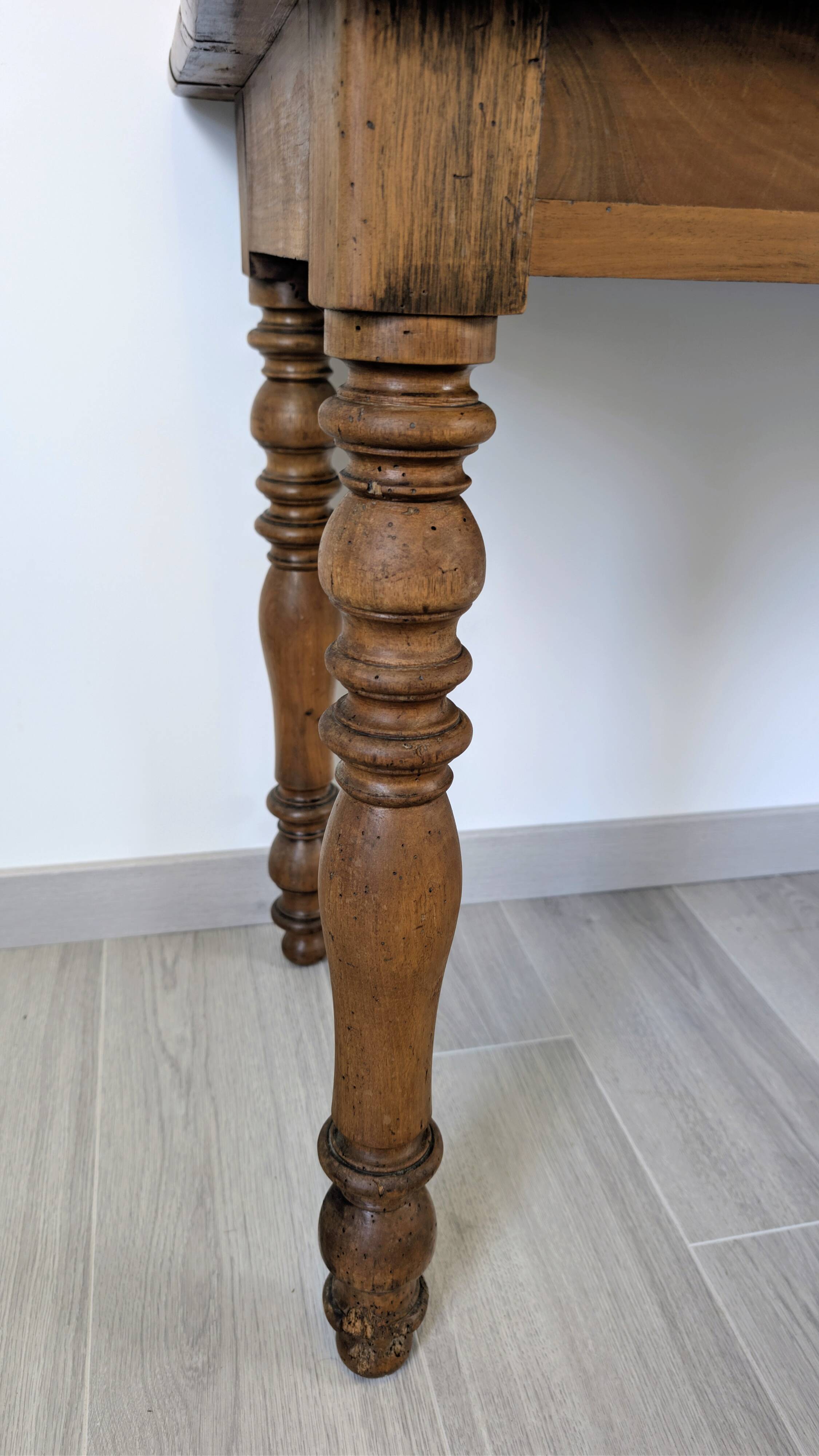 Antique writing table in the Napoleon III style with turned wooden legs.