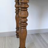 Antique writing table in the Napoleon III style with turned wooden legs.