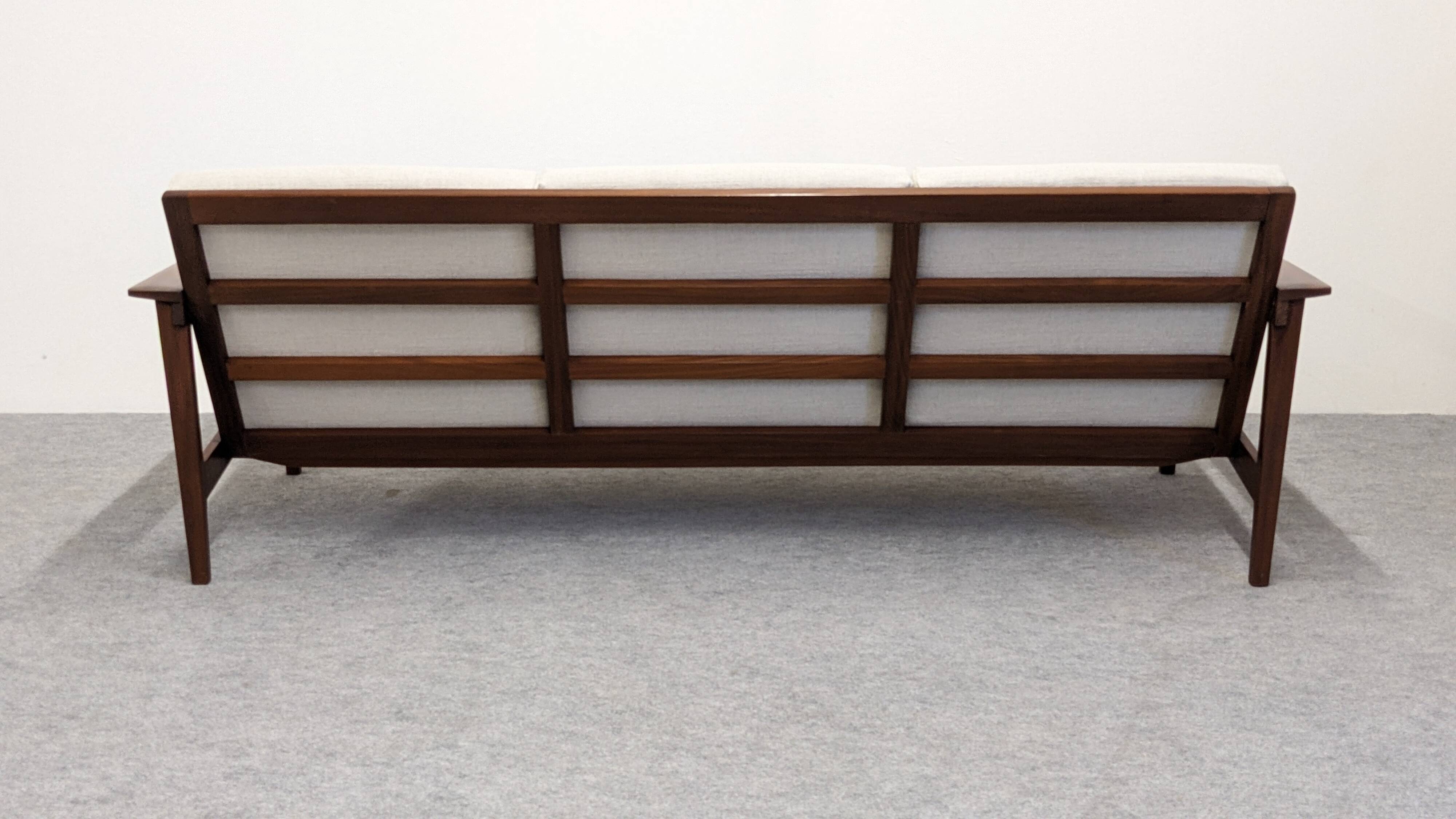 Scandinavian style three-seater sofa in teak, France circa 1950.