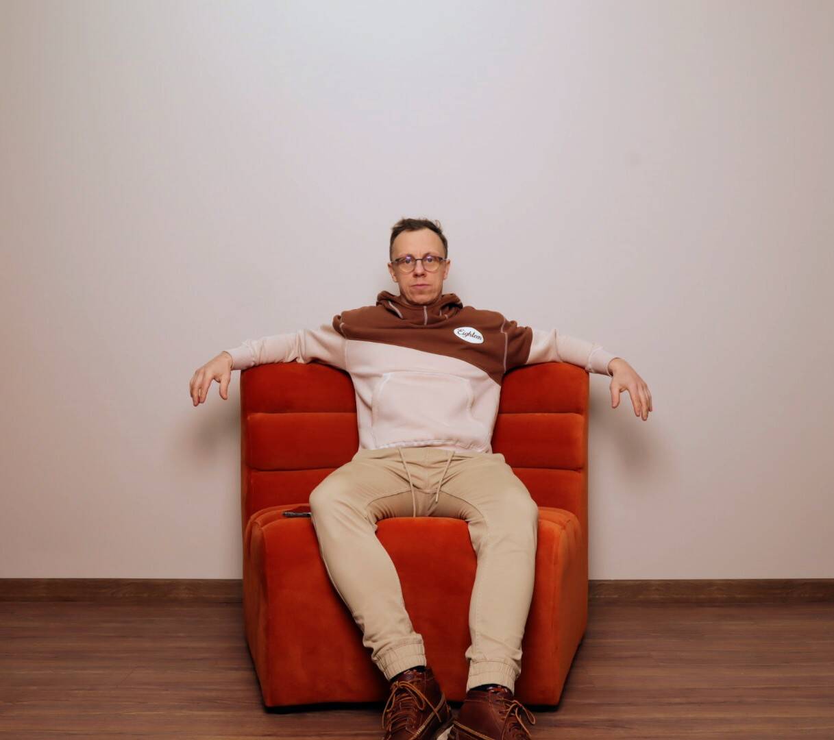 Burnt orange modular sofa for four with a futuristic design.
