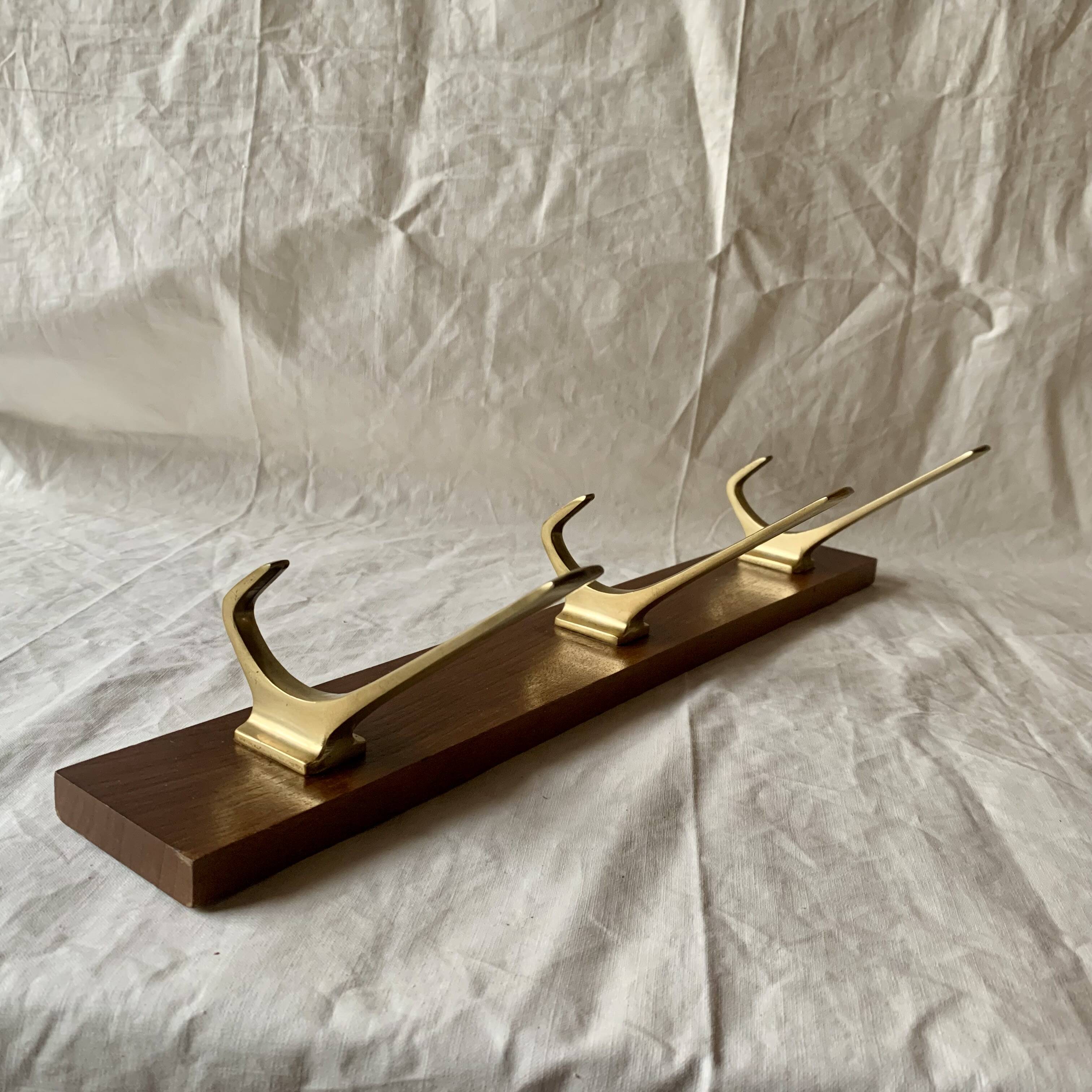 Vintage wooden wall-mounted coat rack with 3 golden cast aluminum hooks