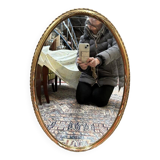 Oval mirror in gilded wood