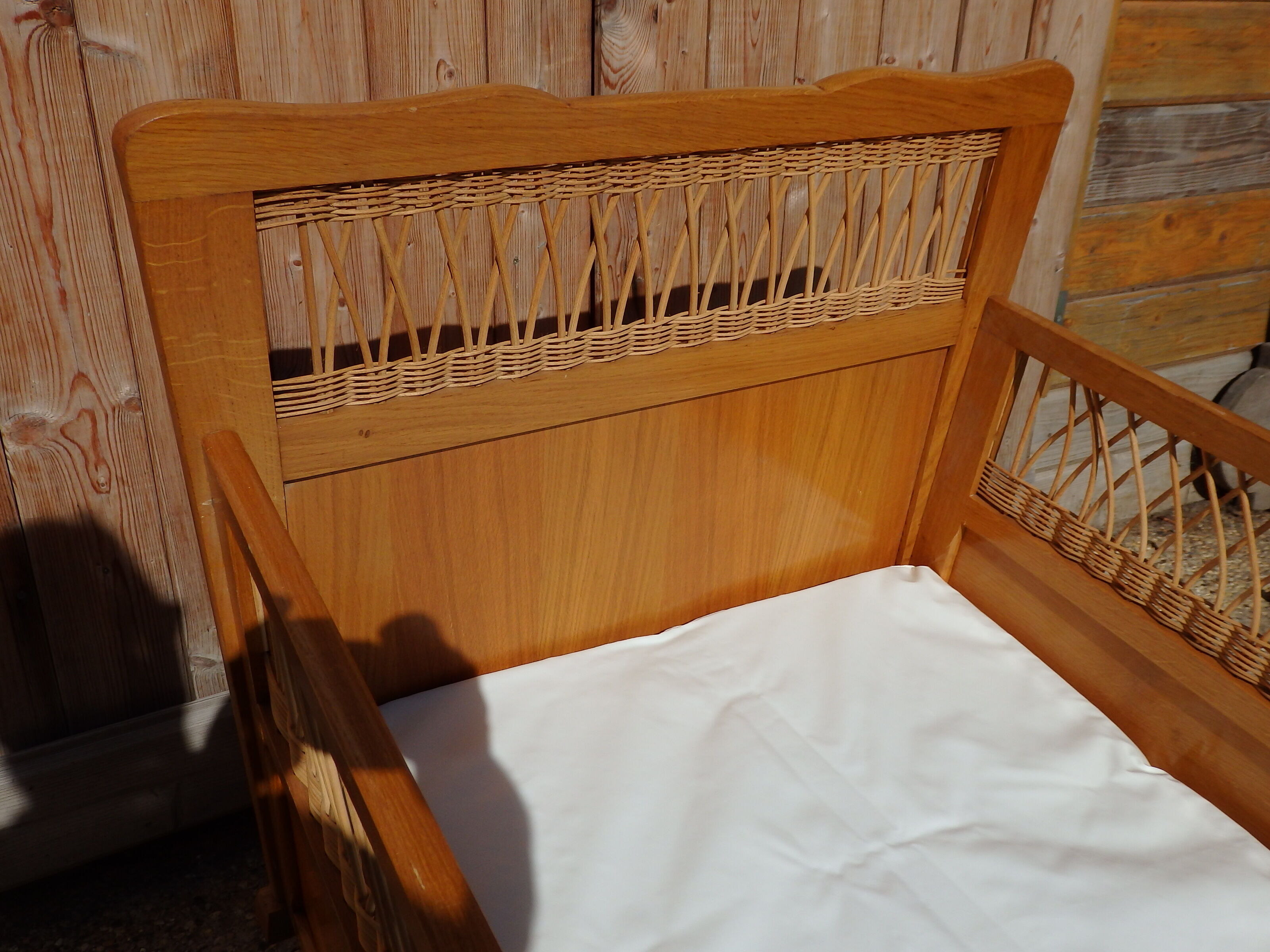 Vintage baby bed in rattan