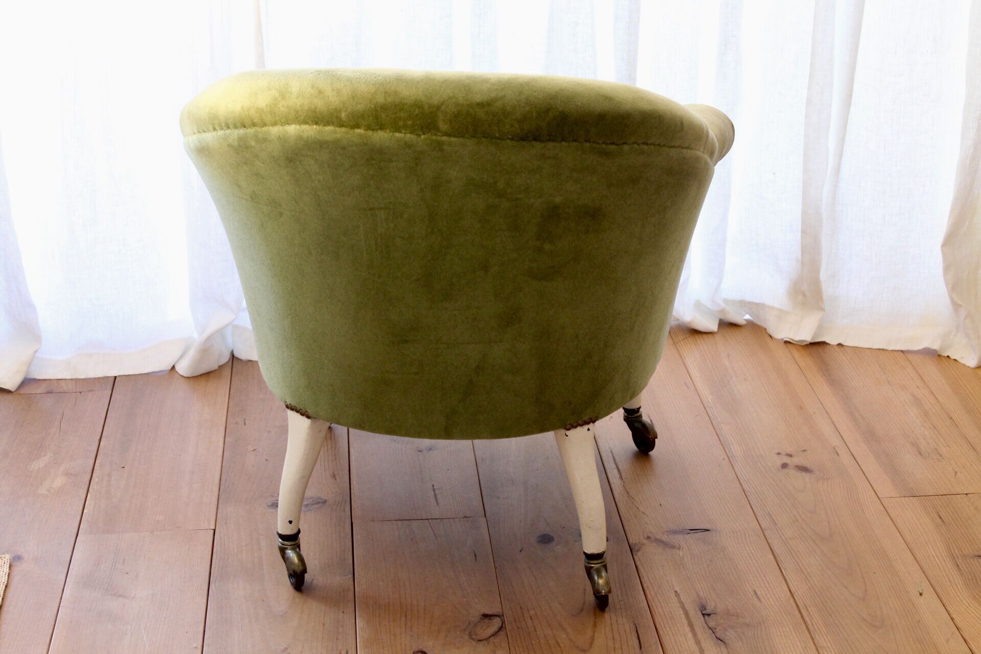 Toad in almond green velvet armchair on castors