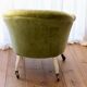 Toad in almond green velvet armchair on castors