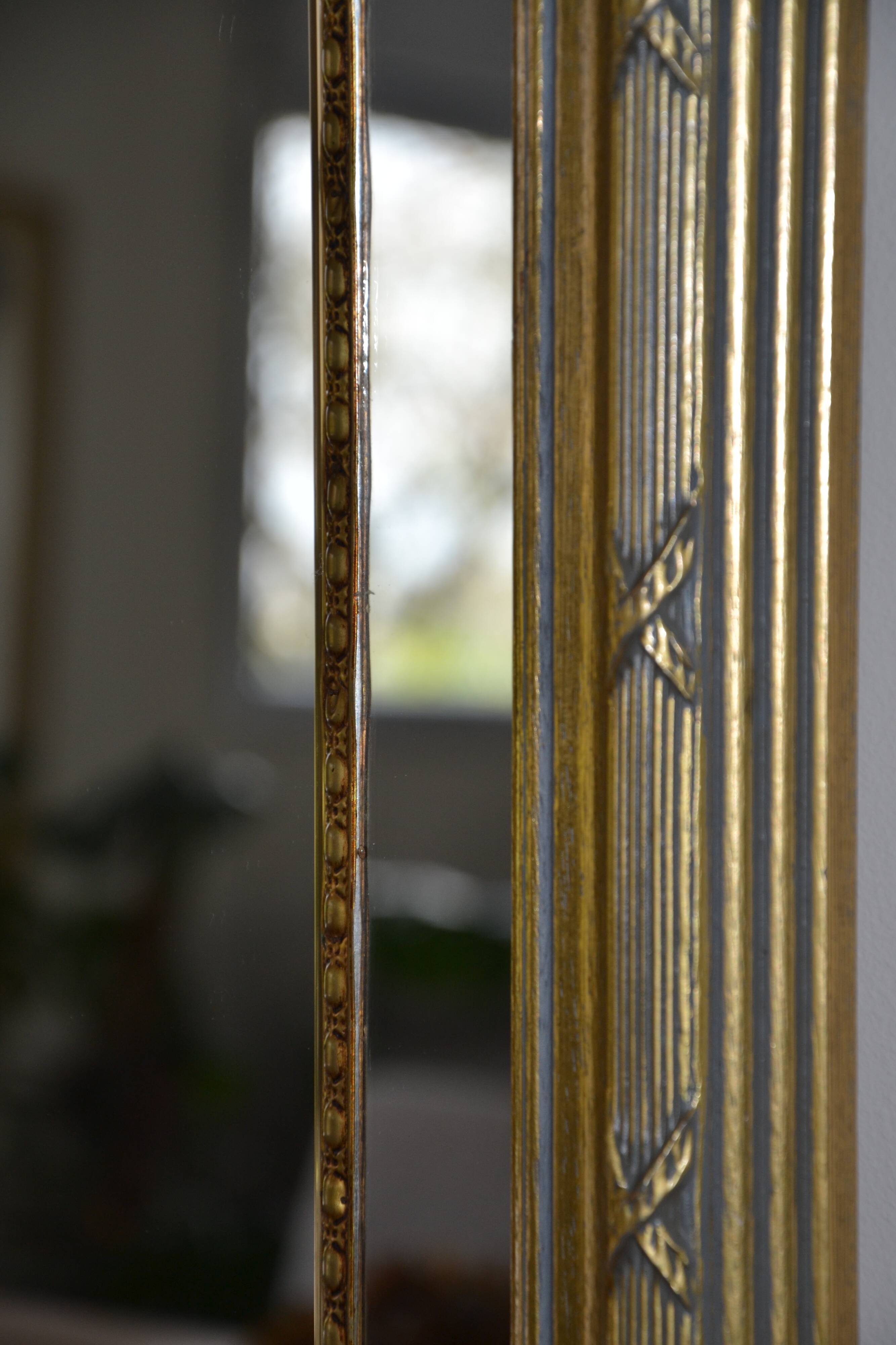 Large mirror with wooden gilded and carved frame.