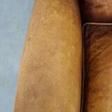 Sheepskin wingback chair with a unique design and a beautiful patina