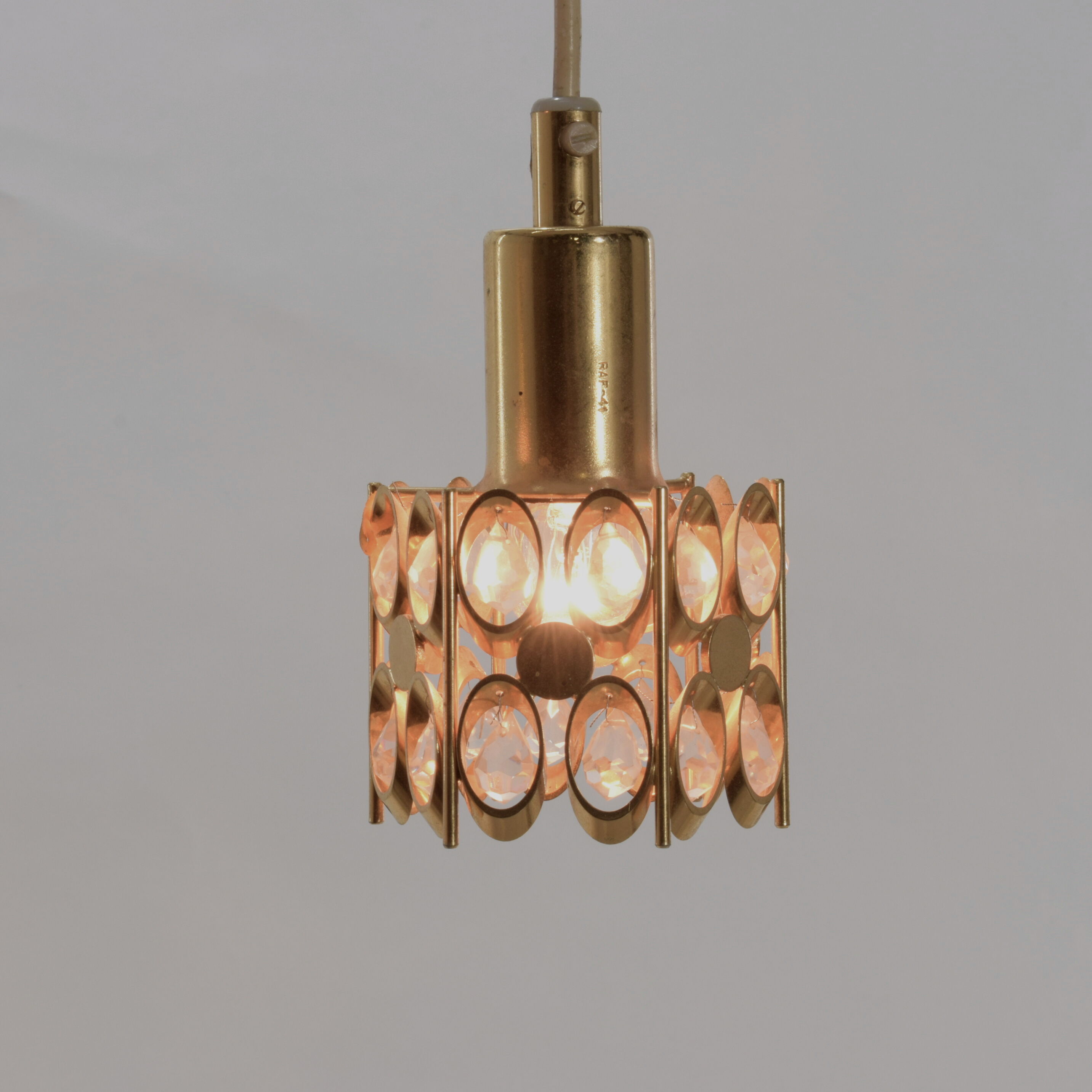Two pendant lights in gilded brass and crystal, by Palwa, design 1960