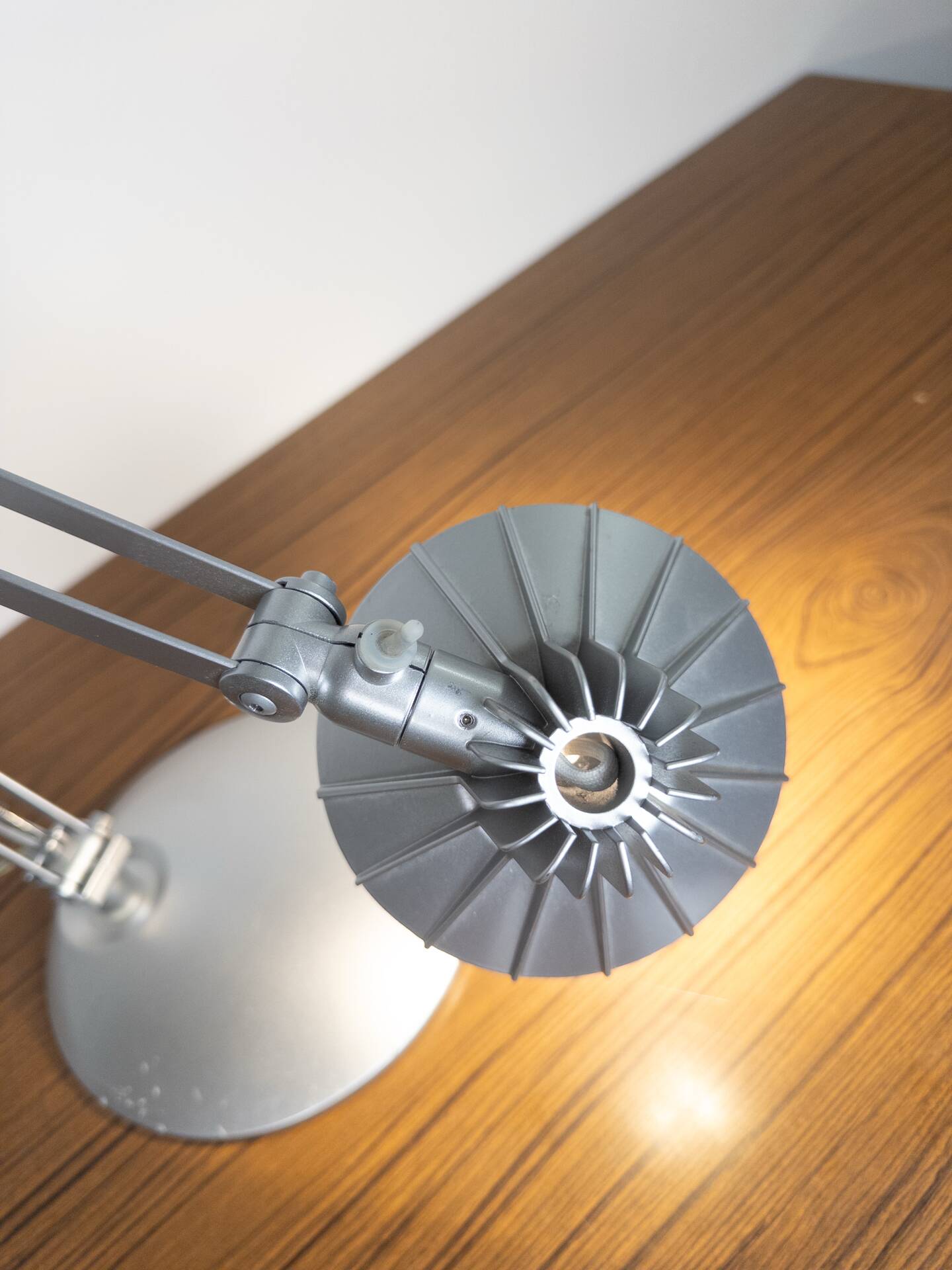Grey LED architect lamp with spring arm and swivel base.
