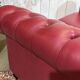 Chesterfield 2-seater leather sofa, modern production from the 2000s.