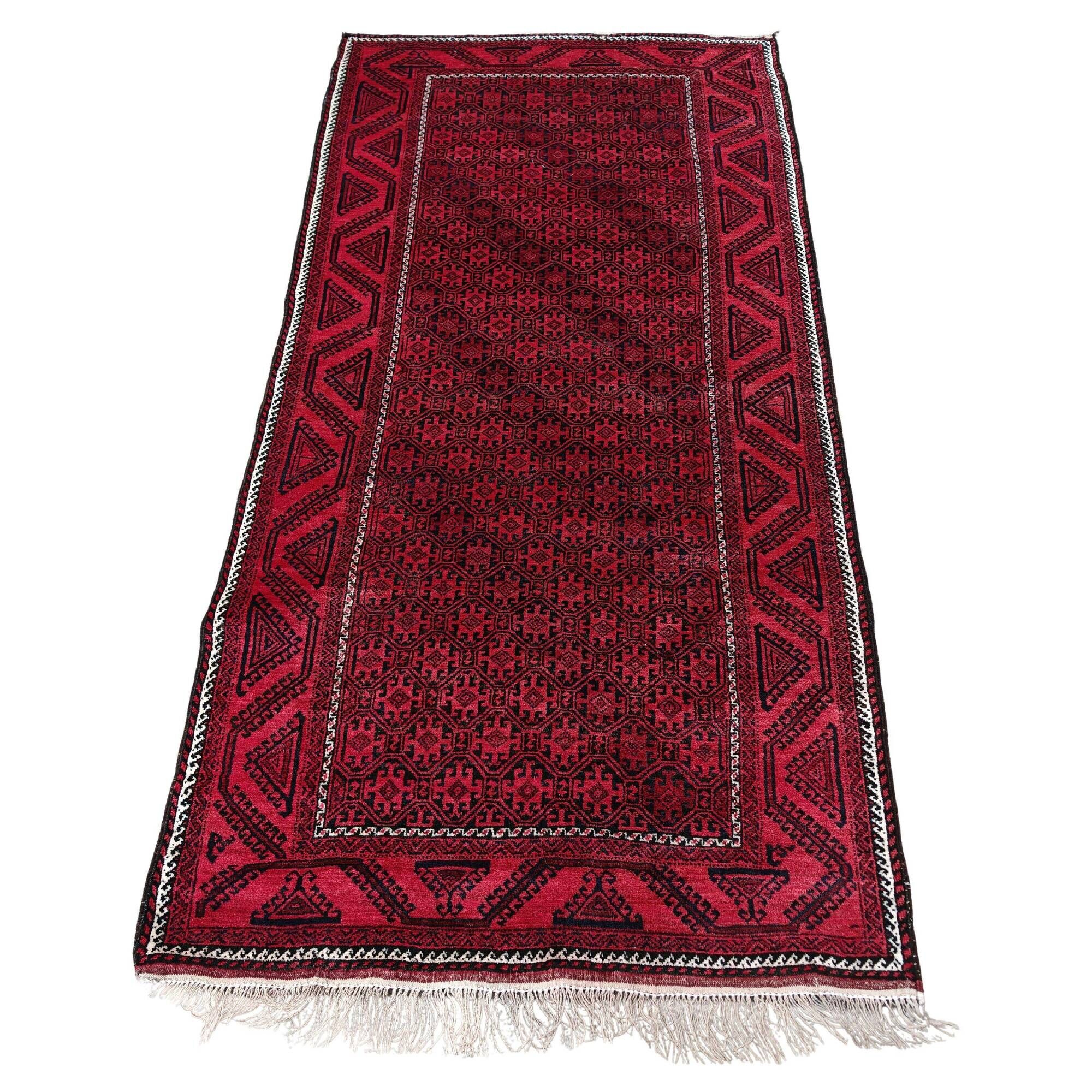 Vintage handmade Baluch rug with geometric pattern from the 1950s.