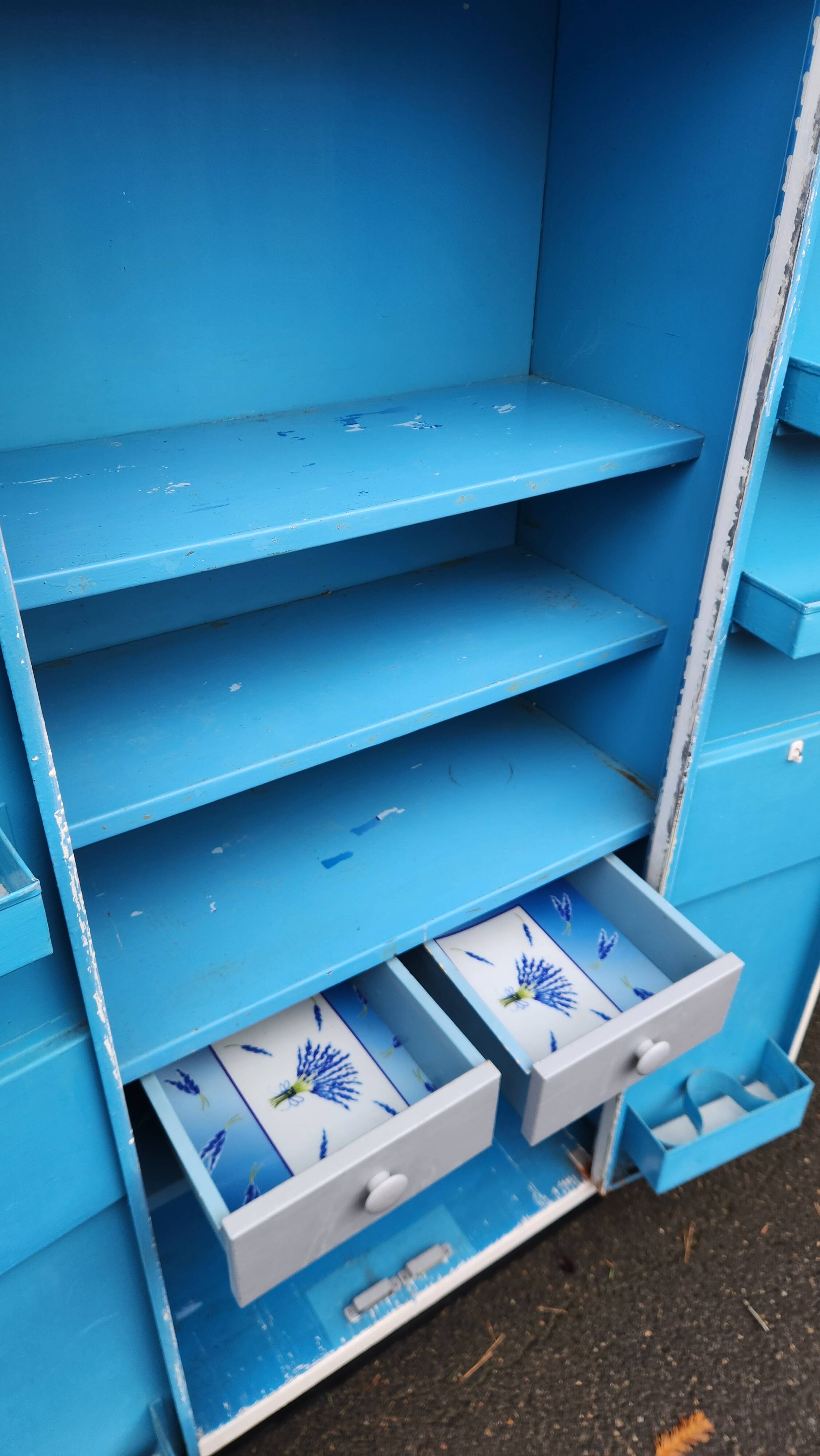 Old industrial metal cabinet in white and blue.