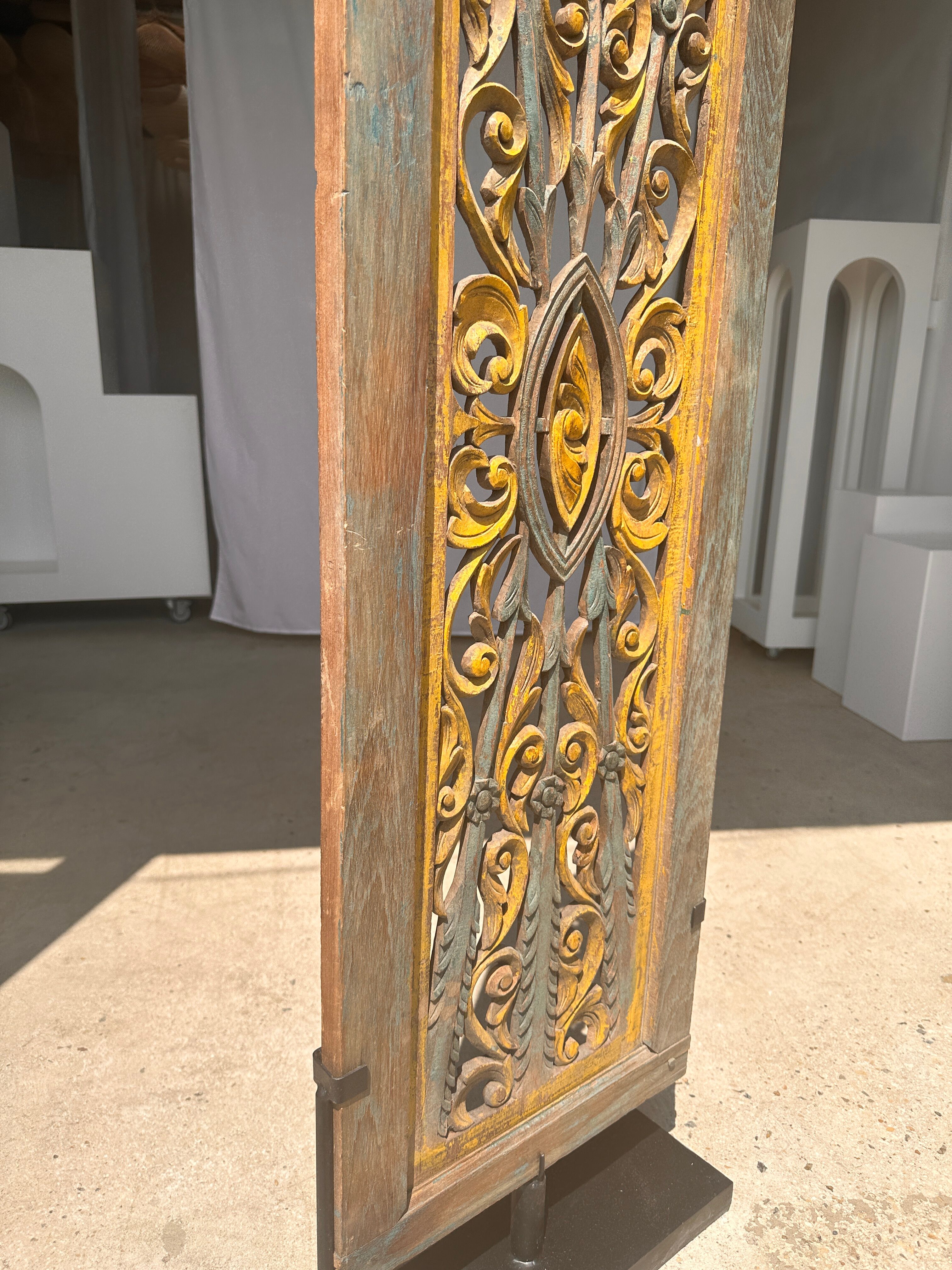 Rectangular Indonesian construction element with blue and yellow plant in carved wood