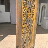 Rectangular Indonesian construction element with blue and yellow plant in carved wood