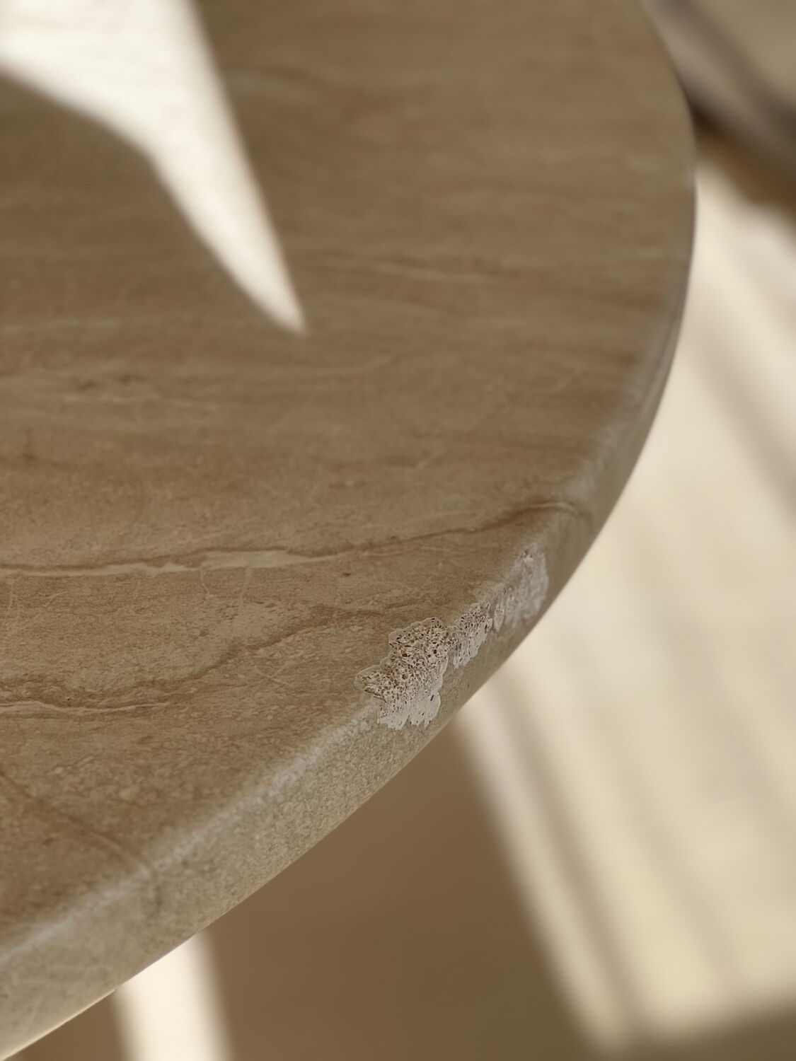Travertine-effect stone dining table
