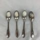 4 small silver metal spoons