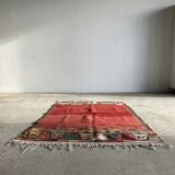 Small wool rug, predominantly red with geometric patterns
