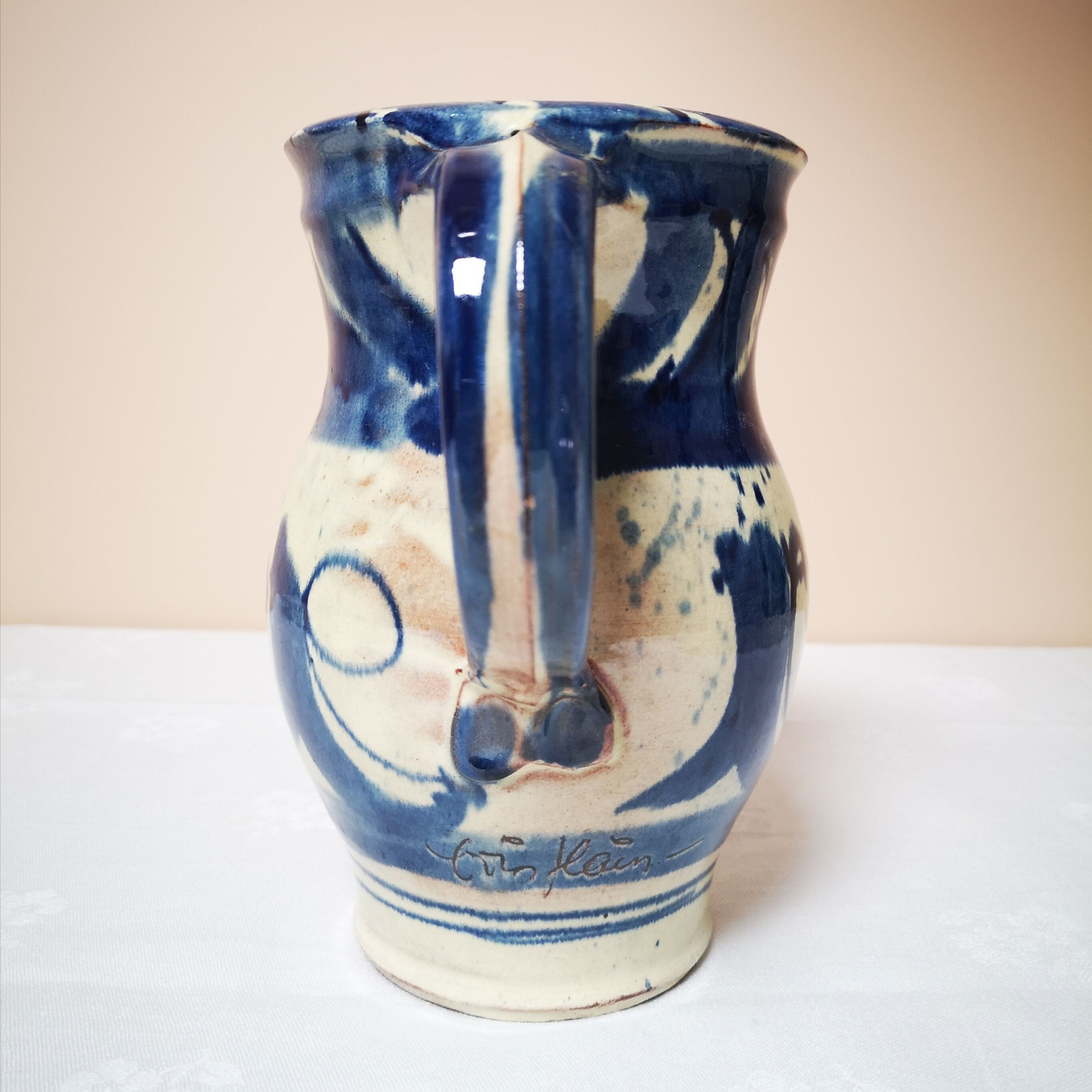 Enamelled ceramic blue pitcher signed by the artist