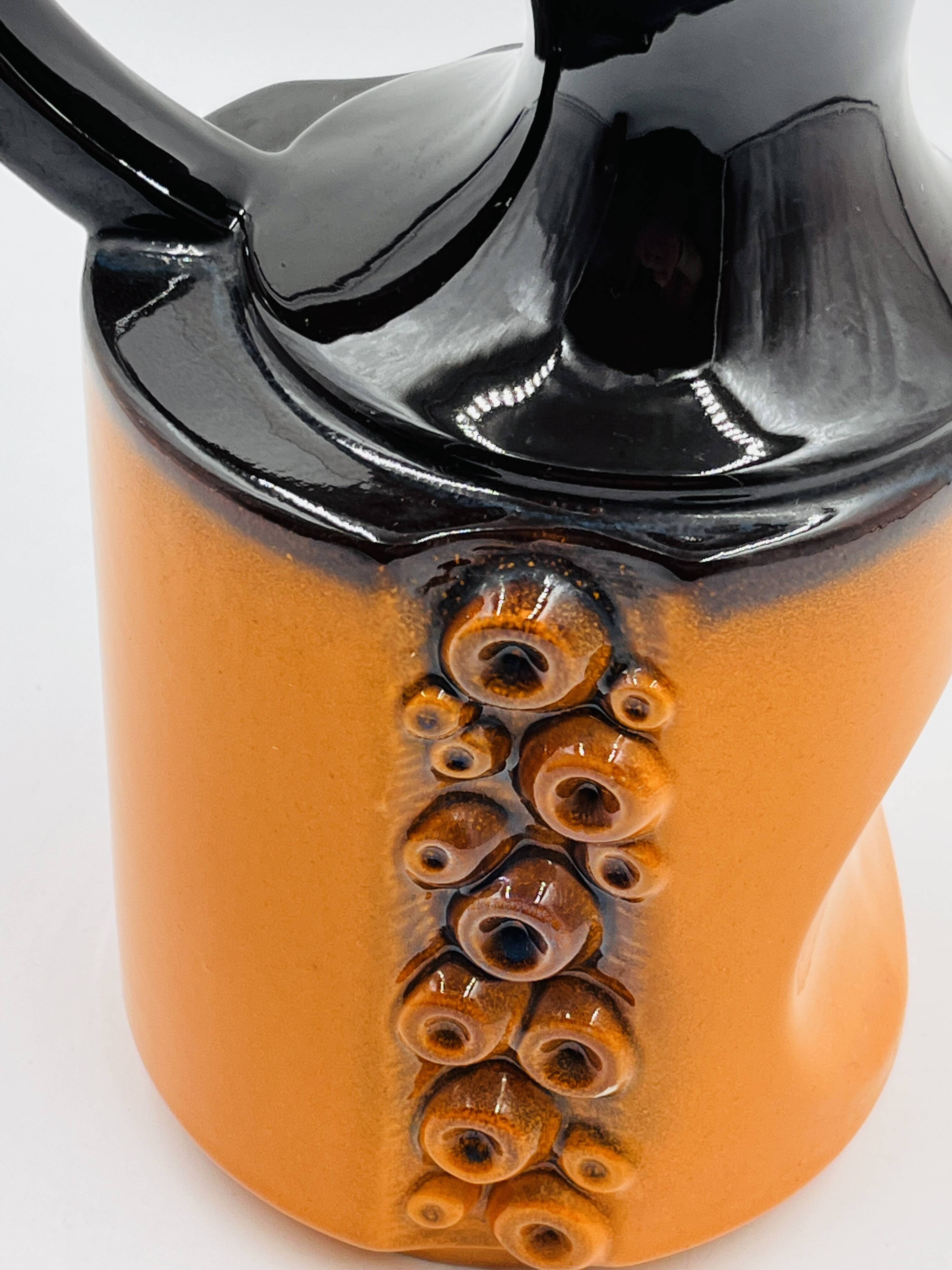 Modernist vase design, orange ceramic with relief cabochons from the 1970s.