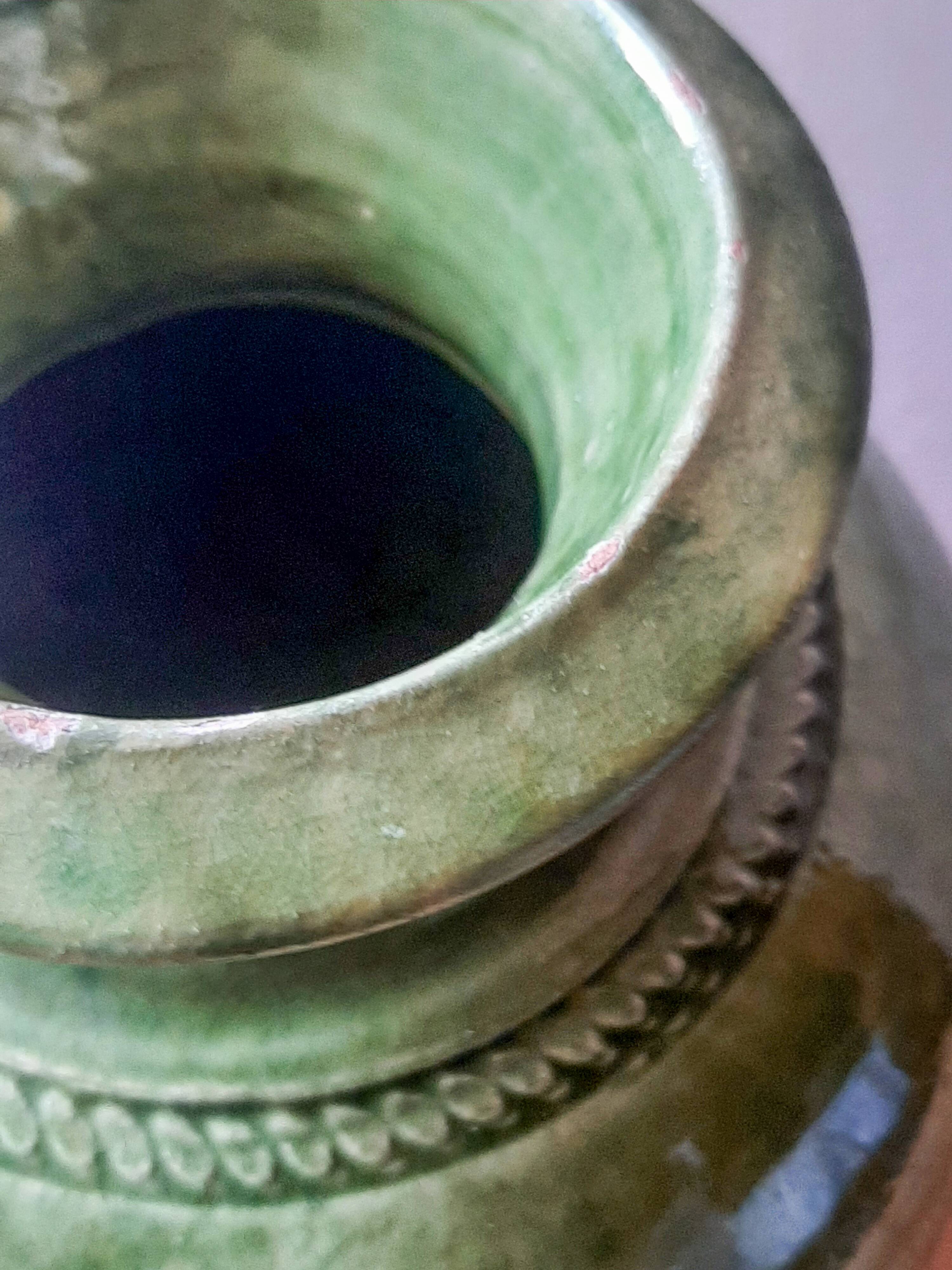 Ancient vase in glazed terracotta with green glaze.