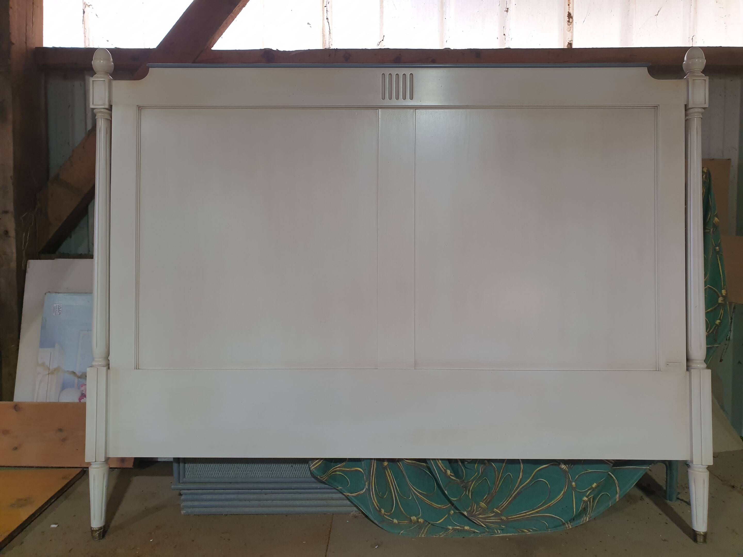 White headboard in Napoleon style with brass feet.