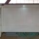 White headboard in Napoleon style with brass feet.