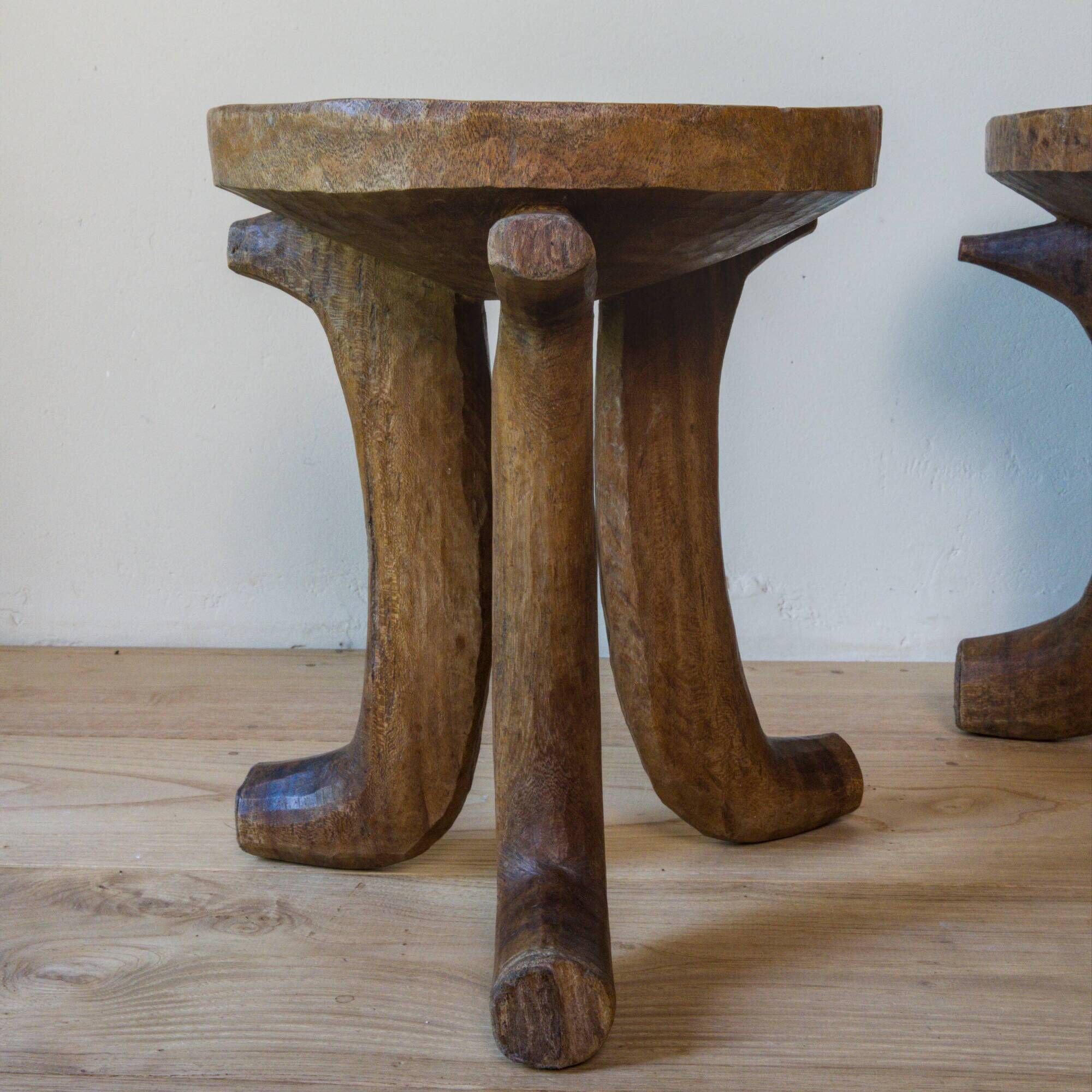 Pair of ancient Ethiopian tripod stools made of monoxyle wood.