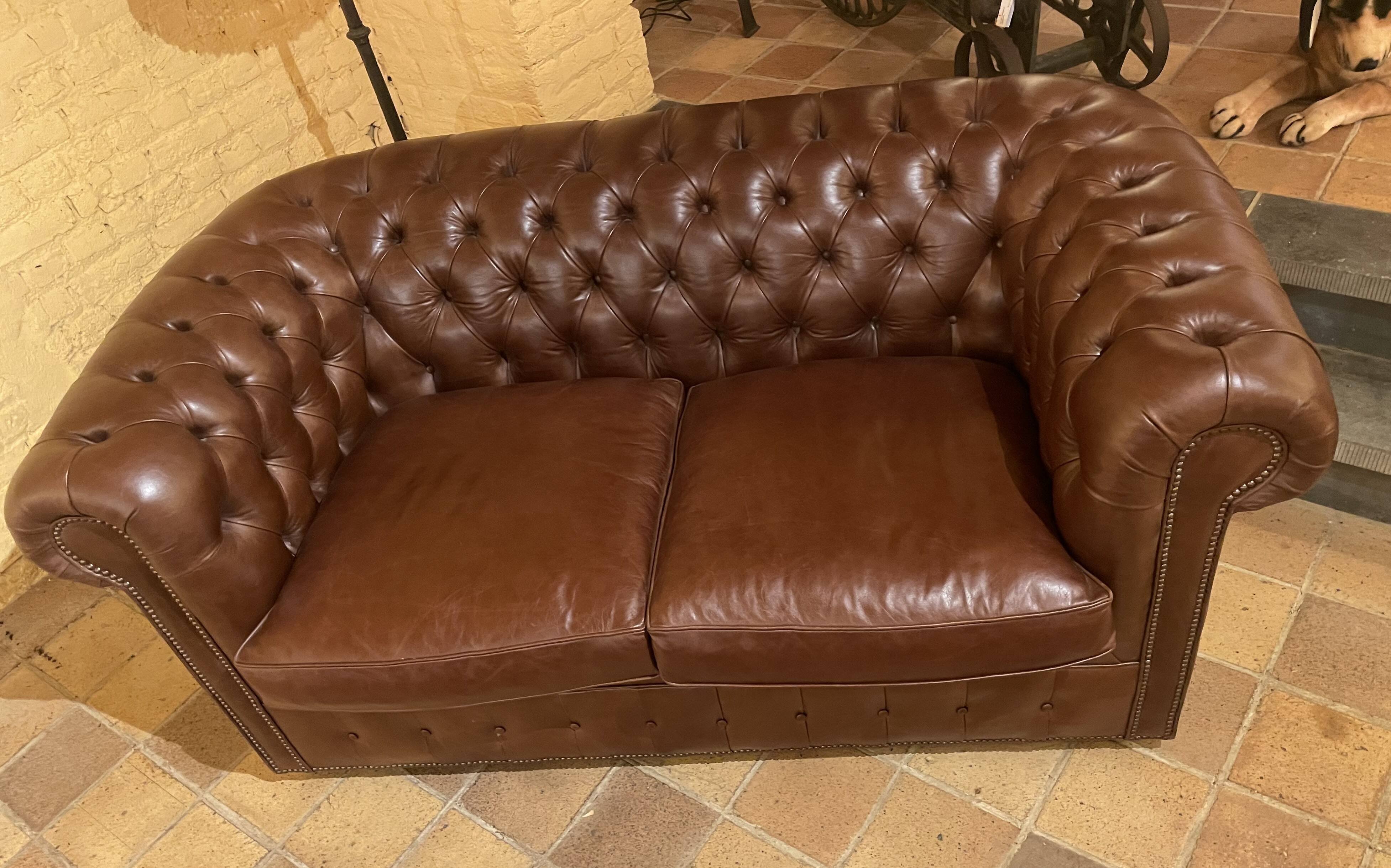 brown leather 2-seater Chesterfield sofa