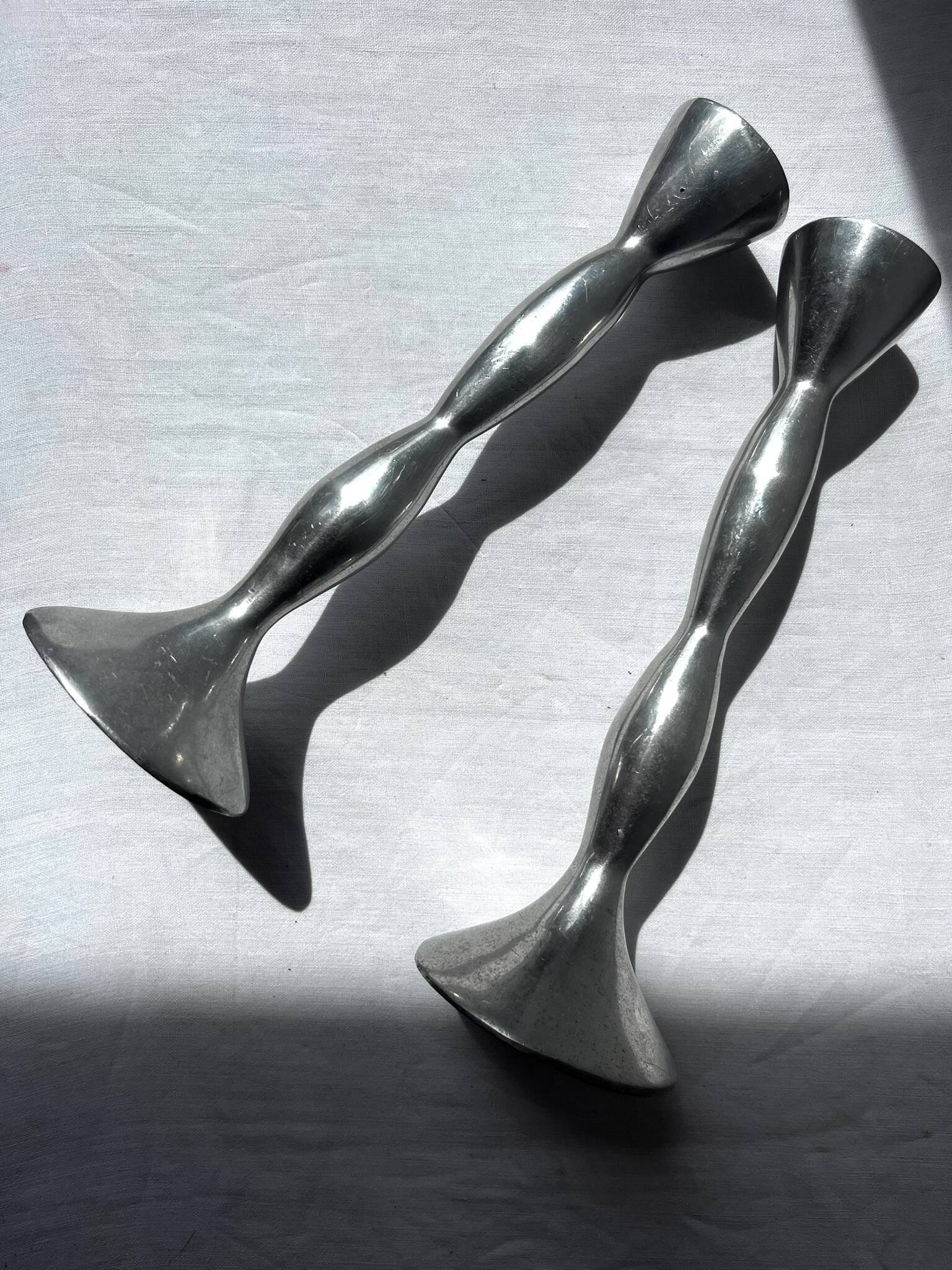Pair of wavy aluminium candle holders