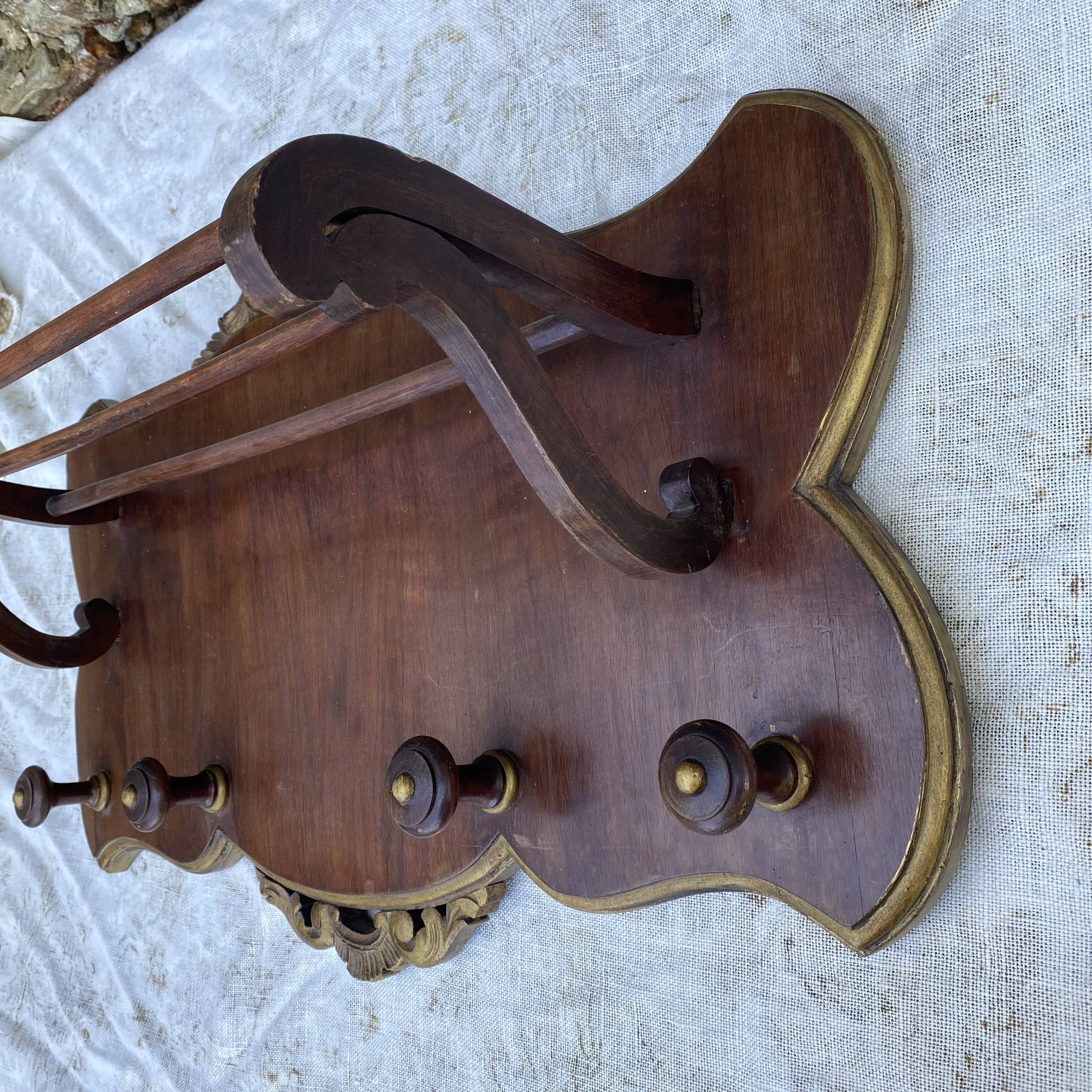 Coat rack and wall-mounted hat rack in an antique style.
