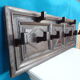 Wall-mounted coat rack in solid oak with 9 hooks.