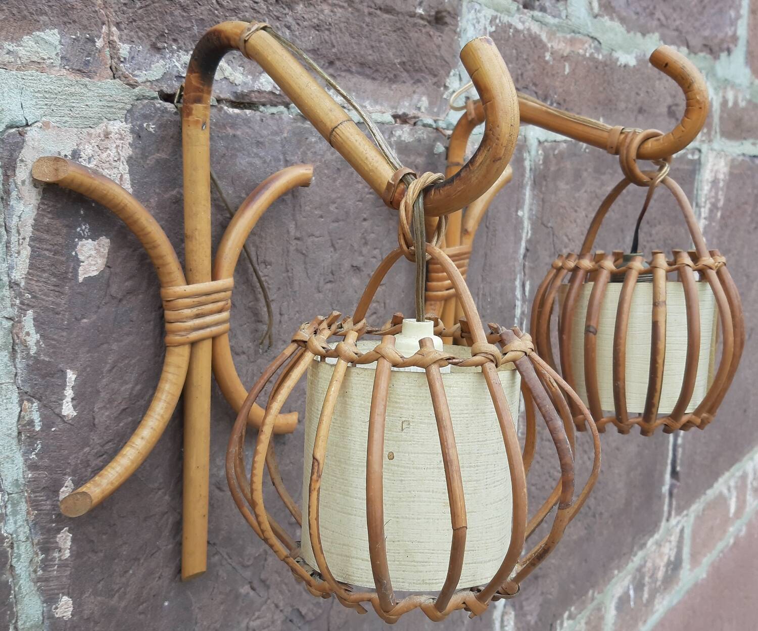 Pair of Louis Sognot rattan wall lights.