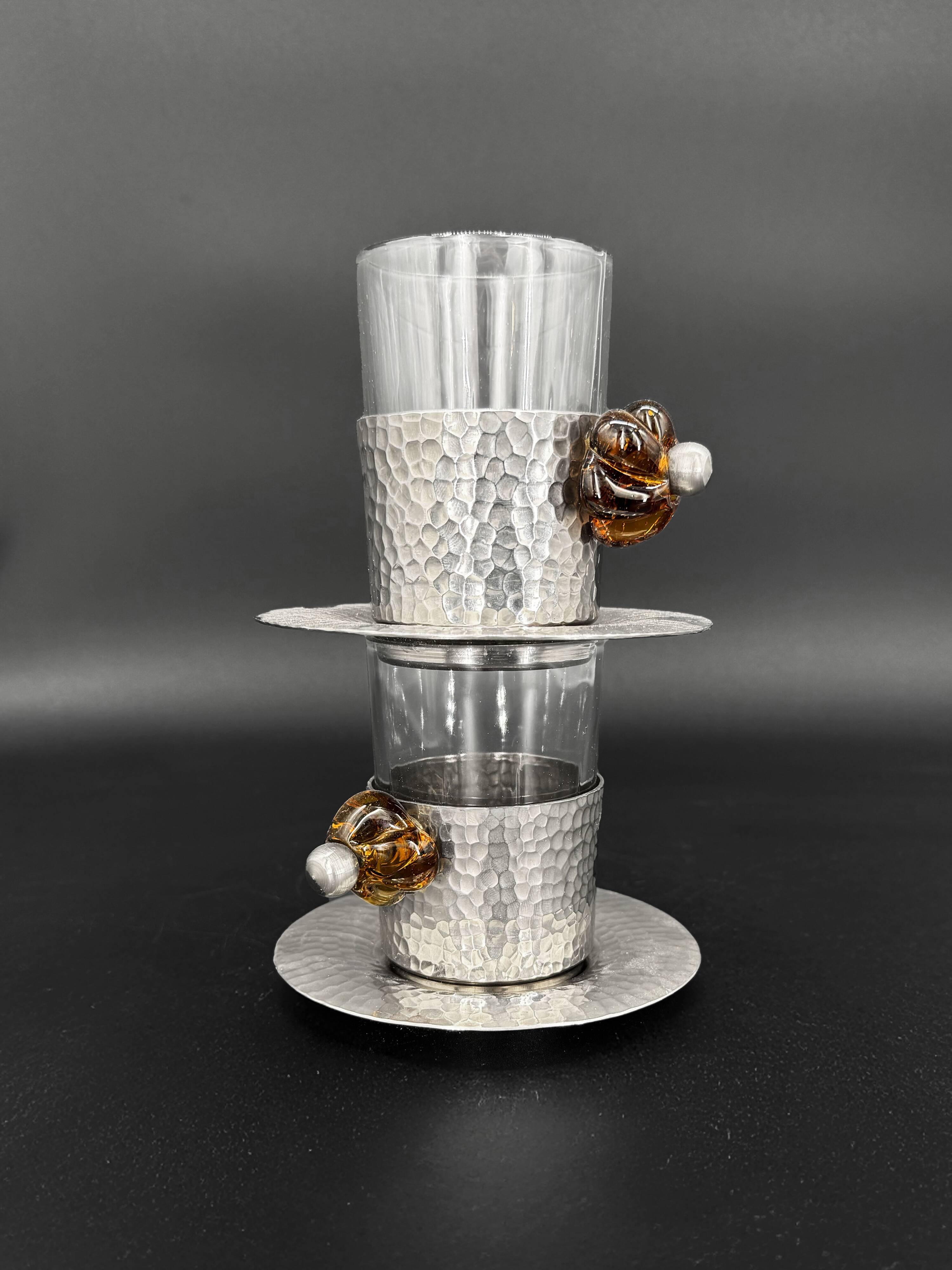 Duo of hammered metal and blown glass cups — handcrafted work