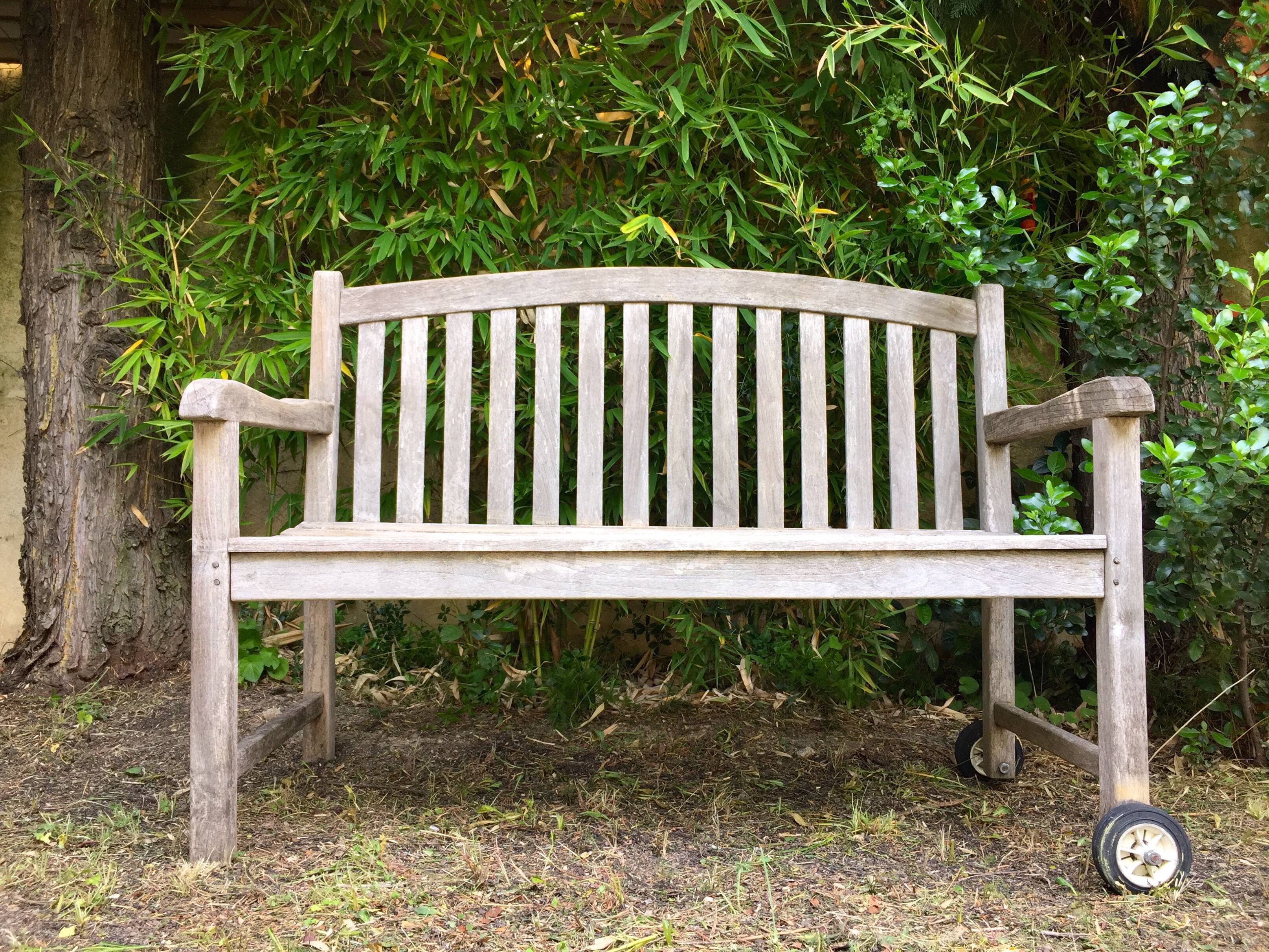 Vintage wooden garden bench with wheels