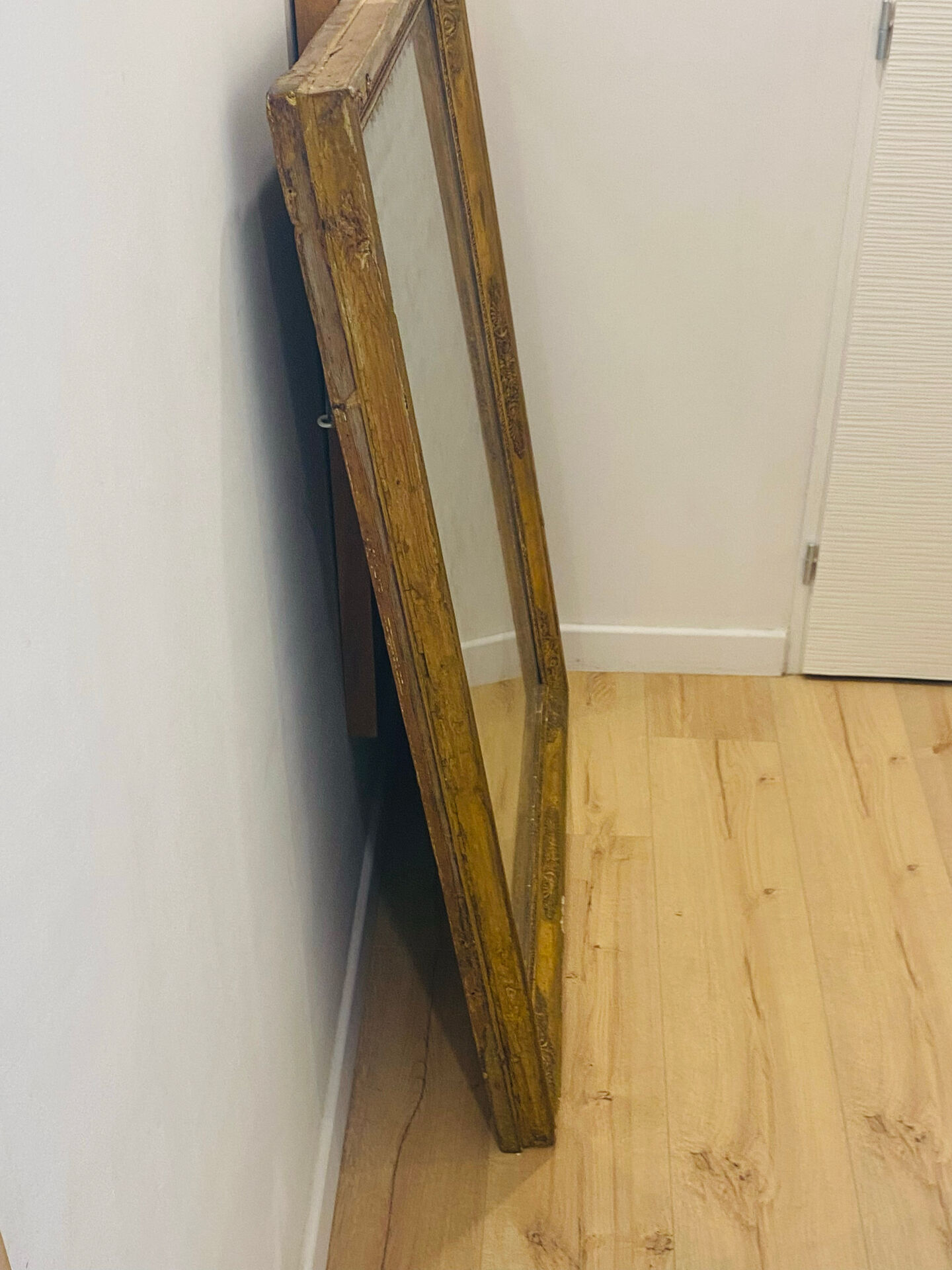 Antique mercury mirror with an Empire gold frame.