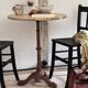 Cast iron base side table with a stone-effect top.