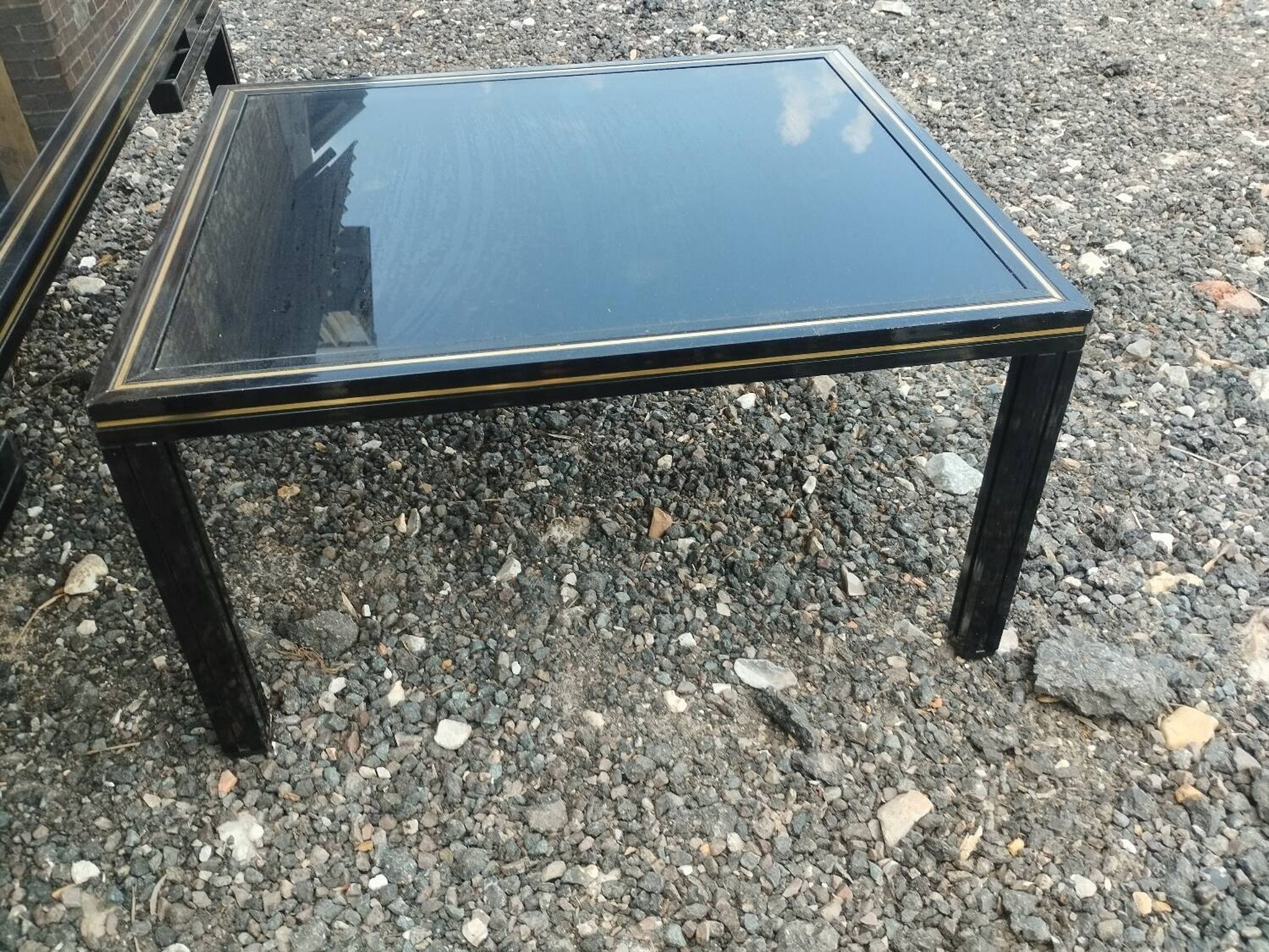 Vintage metal coffee table with glass top.