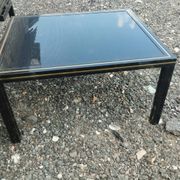 Vintage metal coffee table with glass top.