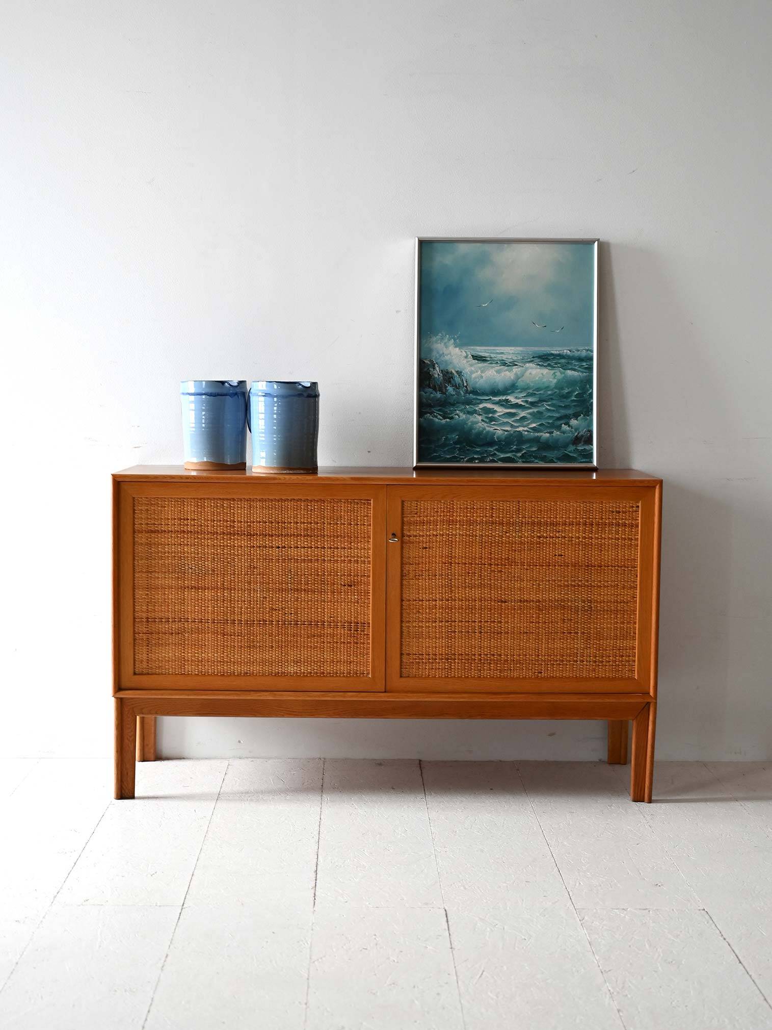 Scandinavian oak cabinet with woven rattan doors