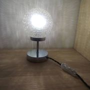 Duo of textured globe lamps with a large play of light.