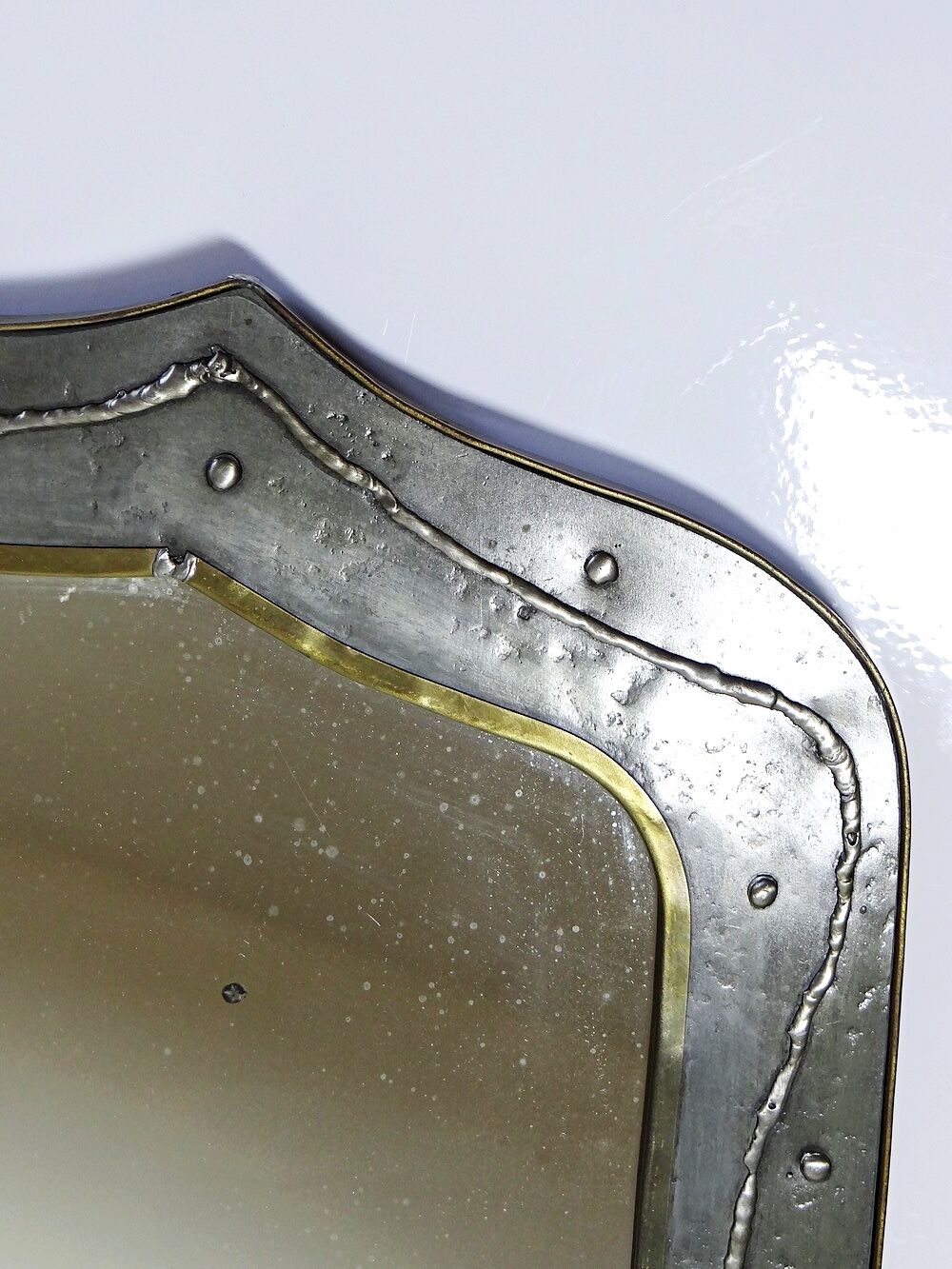 Brutalist mirror by Jean Goardère, brass and tin, 1970s.