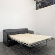 Black leather convertible sofa with goose feather upholstery.