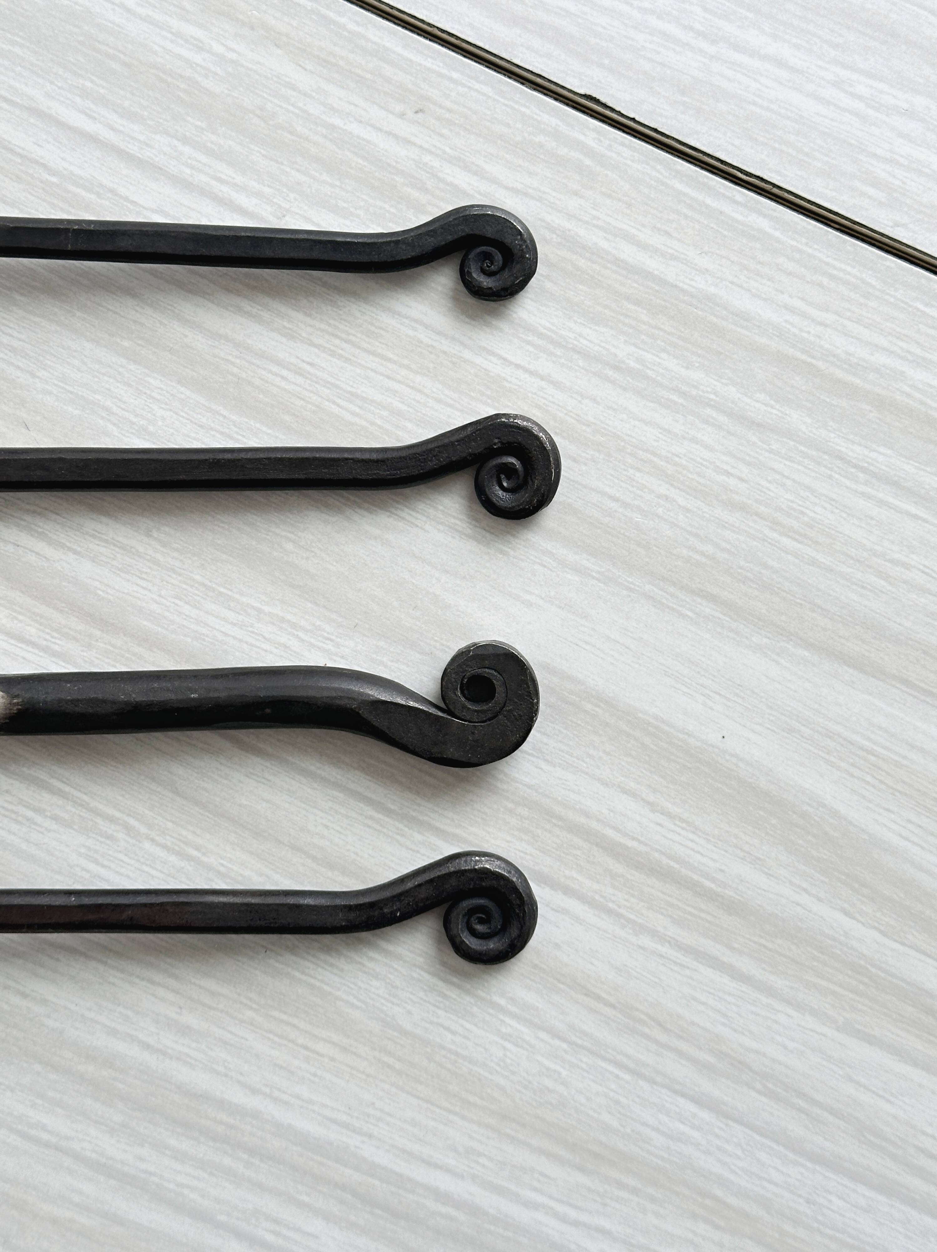 Set of 4 hammered metal cutlery with snail pattern.