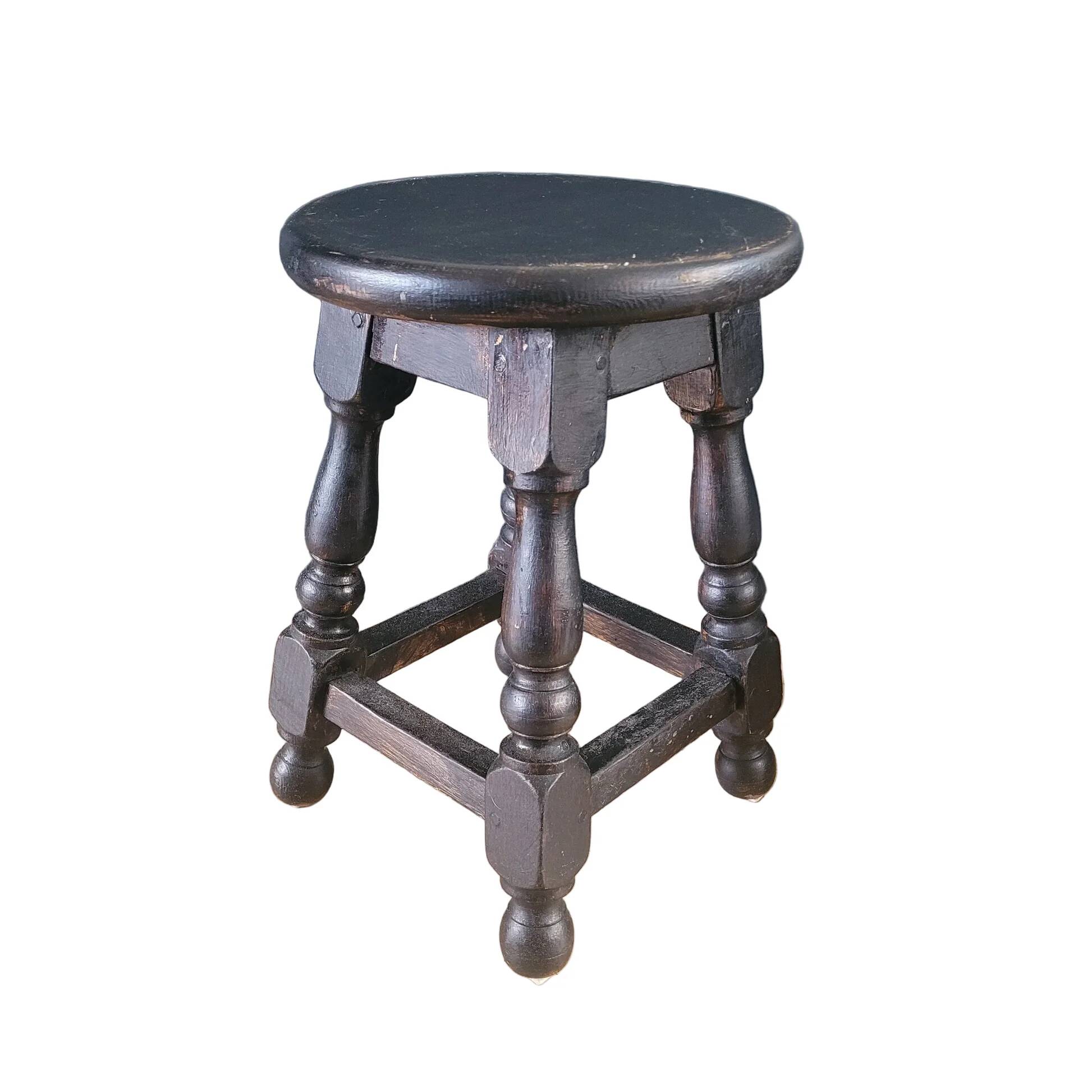 Antique wooden stool with turned legs.