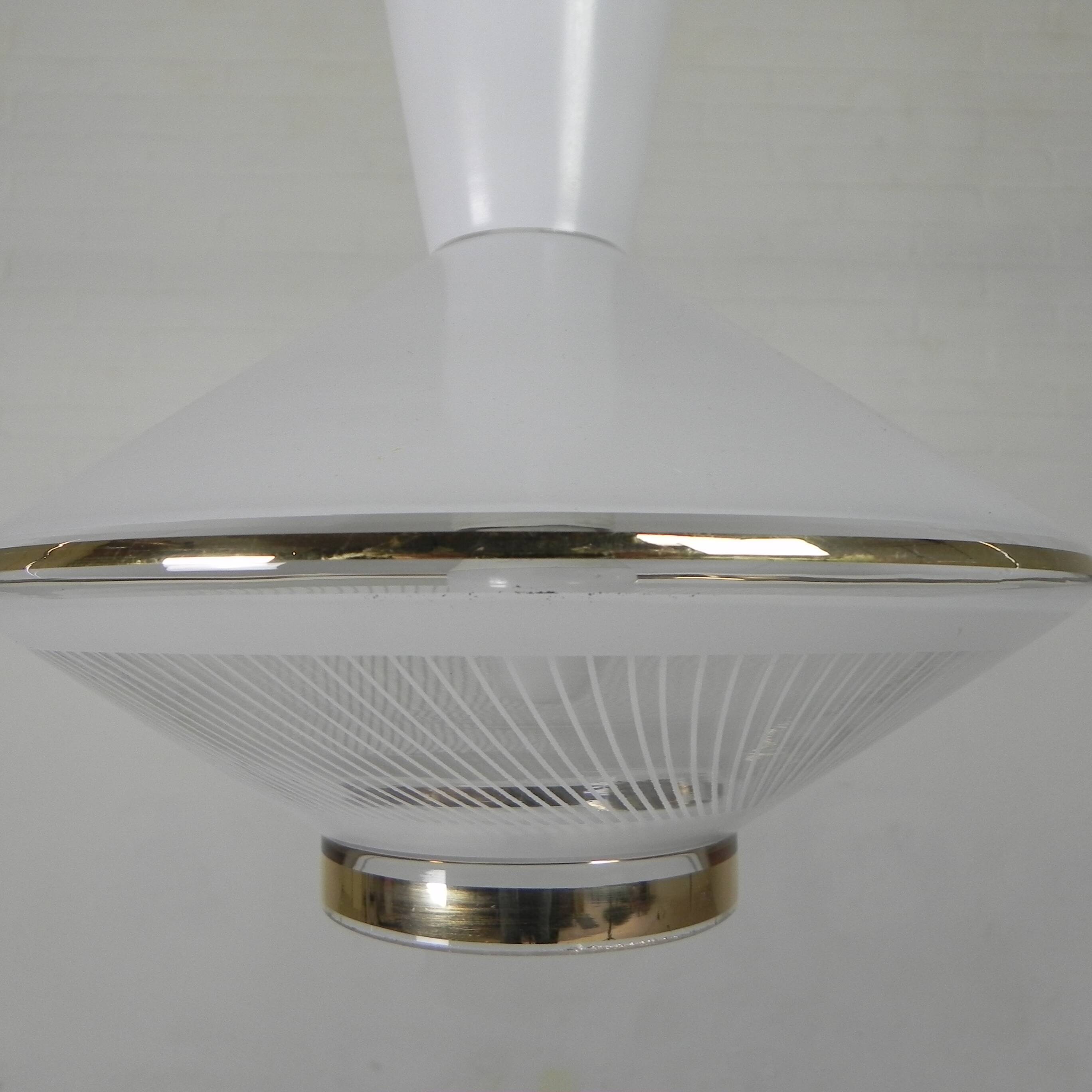 UFO-shaped pendant lamp with white glass on top and clear glass with white