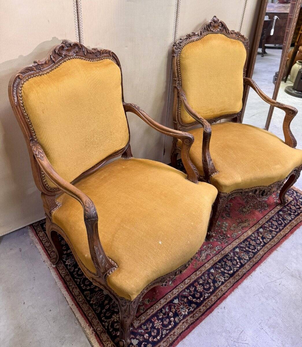 Pair of faux Louis XV armchairs in fully carved walnut